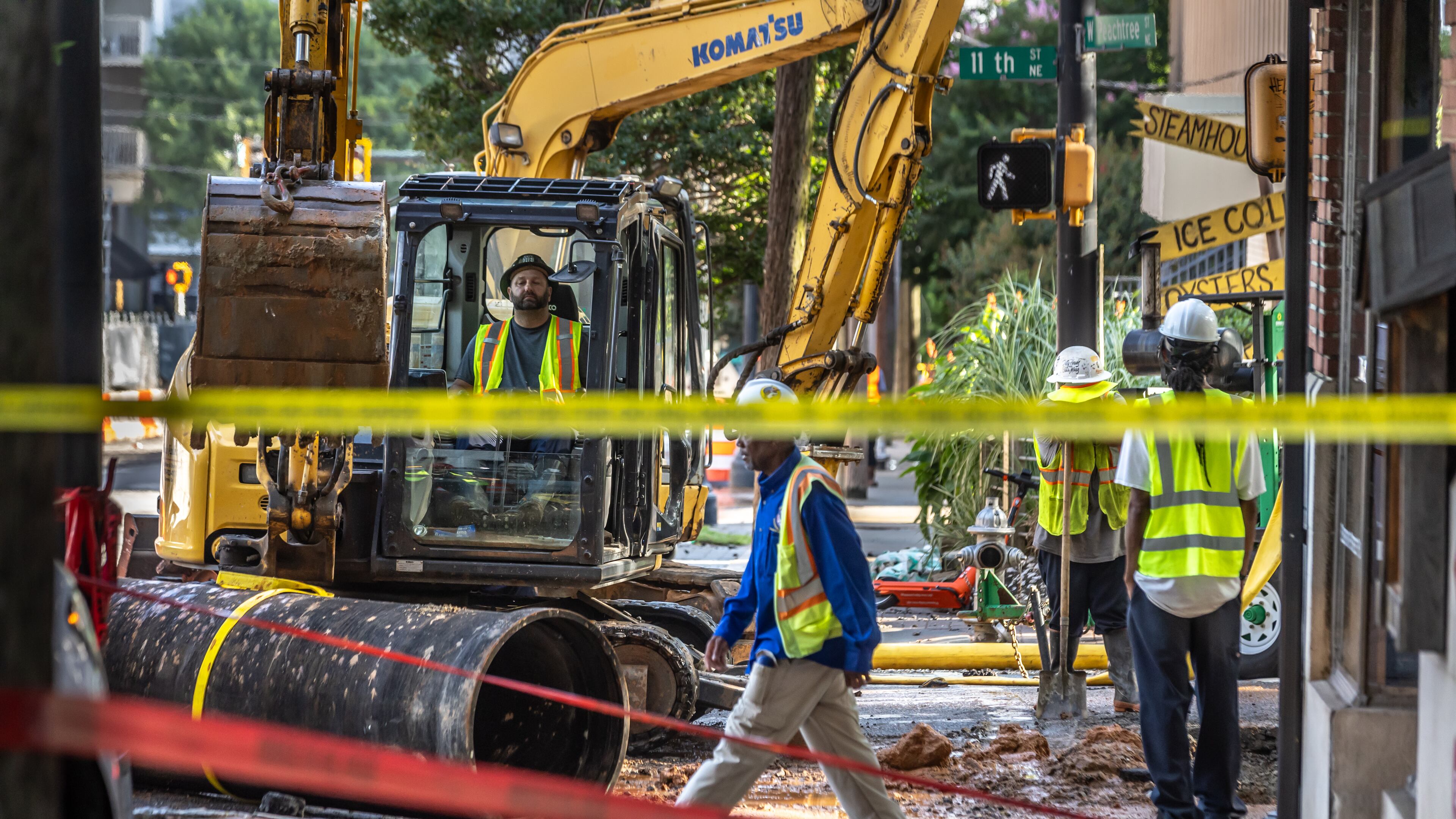 Crews work on a broken water main June 3 on West Peachtree Street in Midtown Atlanta. (John Spink/The Atlanta Journal-Constitution)