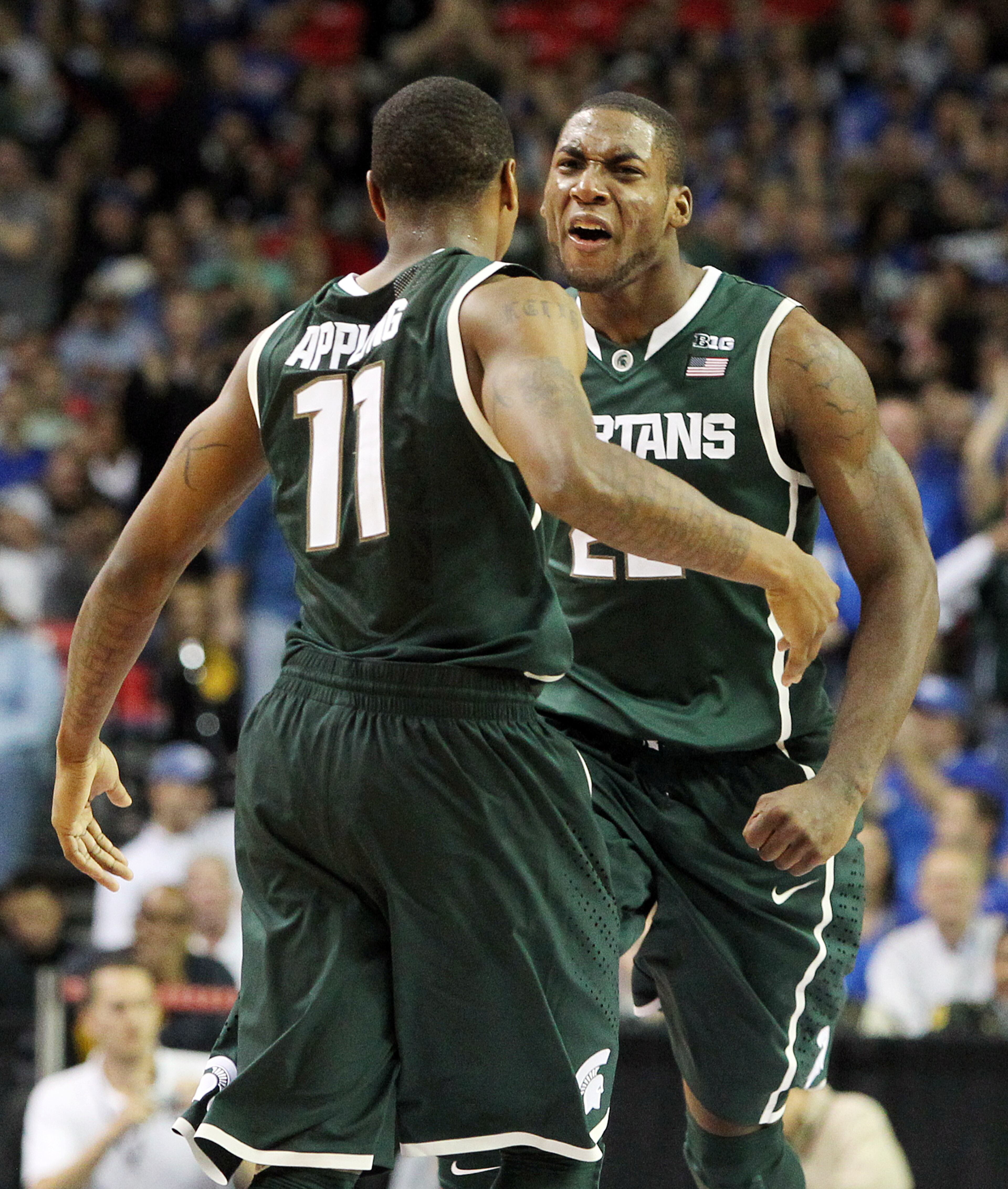 Michigan State guard Keith Appling (11) hits a shot in the final minute of a 67-64 victory over Kansas and celebrates with Branden Dawson, right, in the Champions Classic at the Georgia Dome in Atlanta on Tuesday, Nov. 13, 2012. CURTIS COMPTON / CCOMPTON@AJC.COM