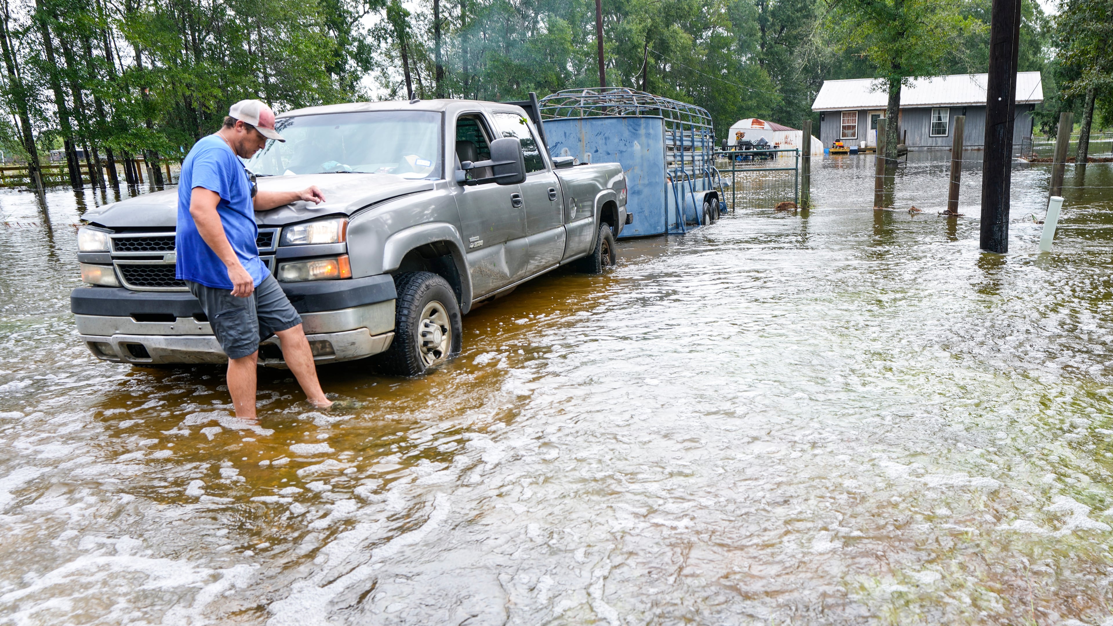 Chase Barfield walks to his truck as he takes belongings and his dogs away from floodwaters around his house in the aftermath of Tropical Storm Edouard near Honey Island, Texas, Wednesday, Sept. 2, 2026. (Brett Coomer/Houston Chronicle via AP)