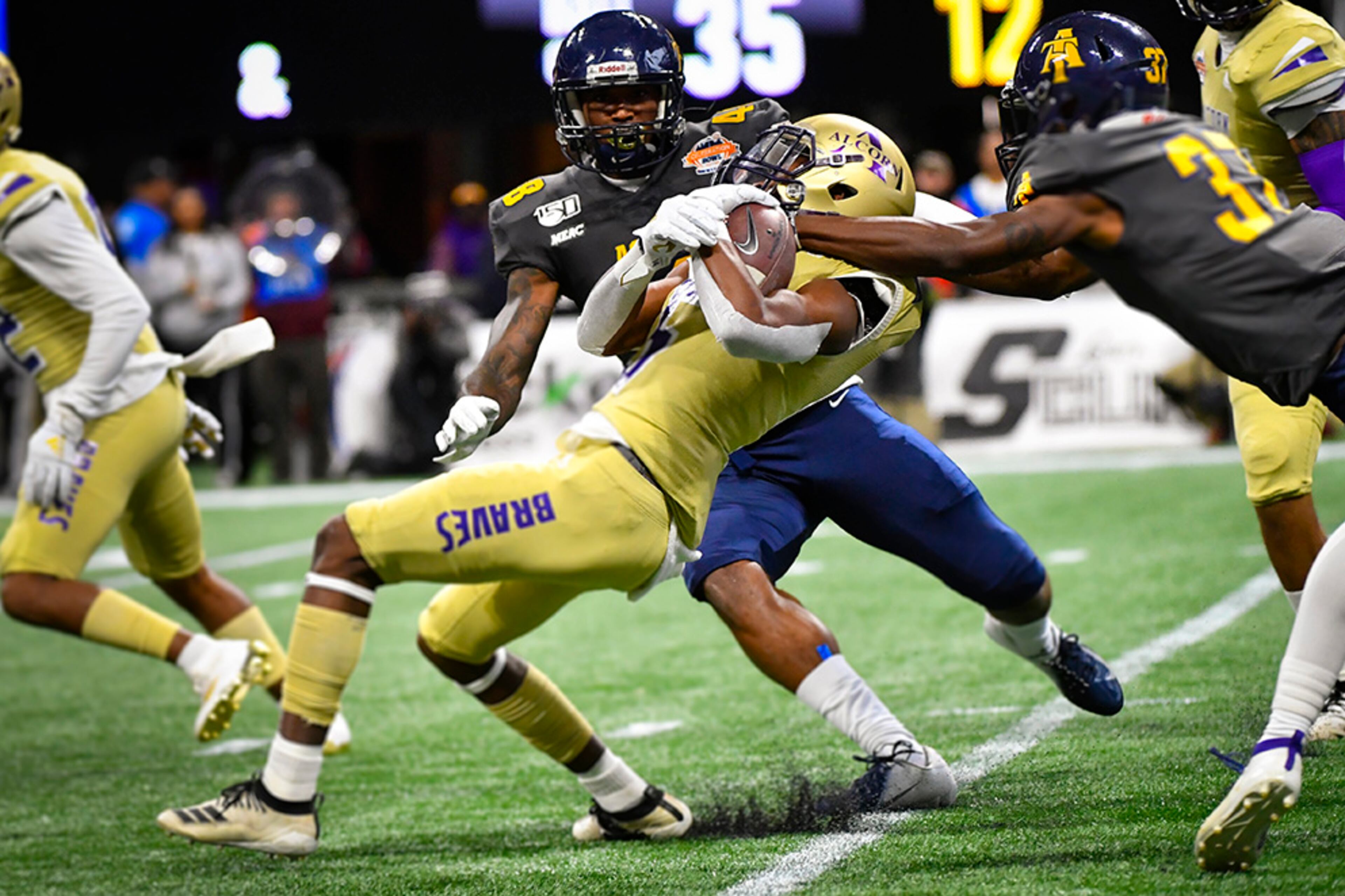Alcorn State running back Niko Duffey is brought down by North Carolina A&T defensive back Janaz Sumpter (37) as linebacker Stephen Davis Jr. also defends on the opening kickoff during the first half of the Celebration Bowl Saturday, Dec. 21, 2019, at Mercedes-Benz Stadium in Atlanta.