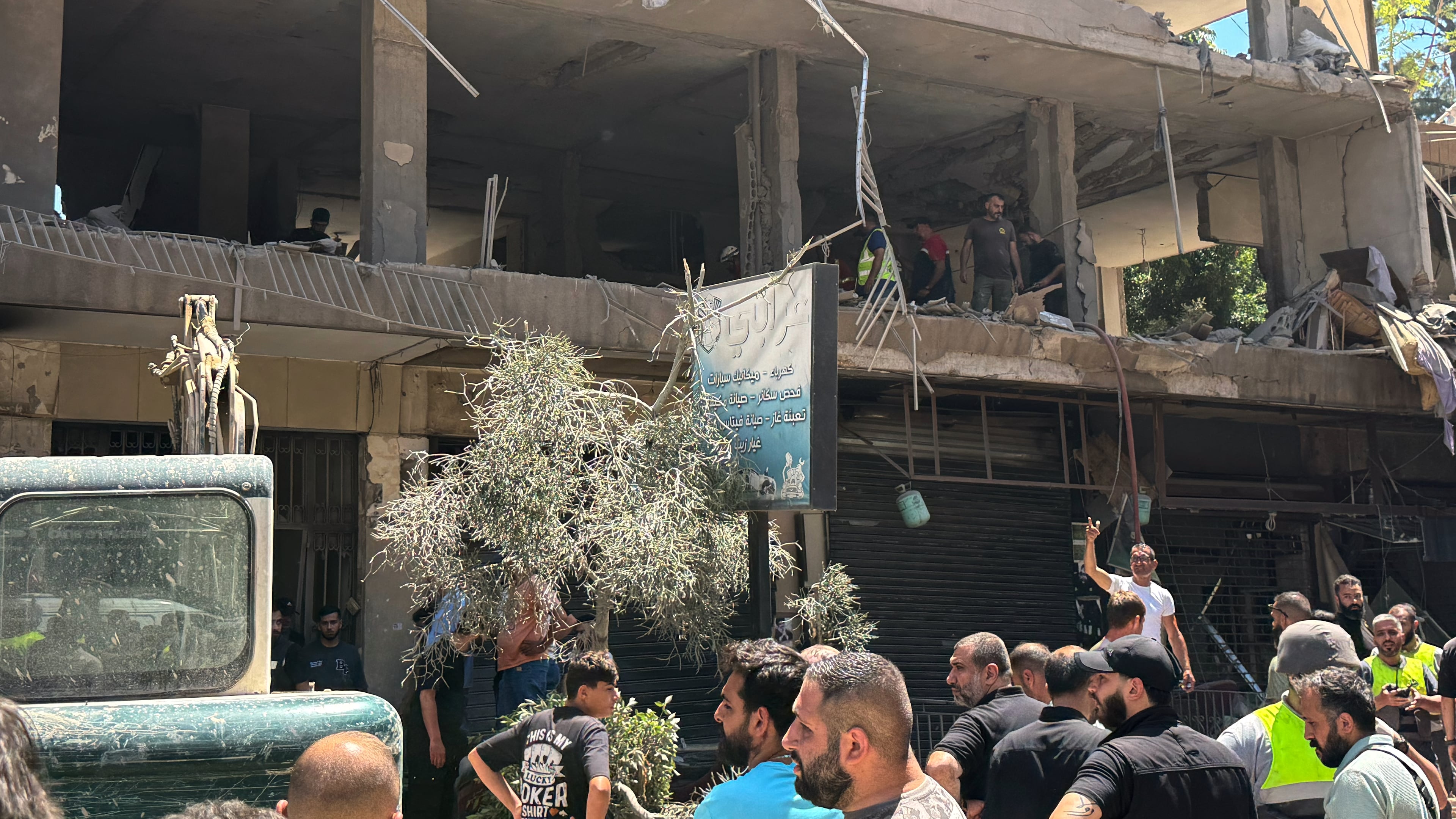 People gather at the site of an Israeli airstrike that struck an apartment in Dahiyeh, Beirut's southern suburbs, Lebanon, Sunday, June 14, 2026. (AP Photo/Bilal Hussein)