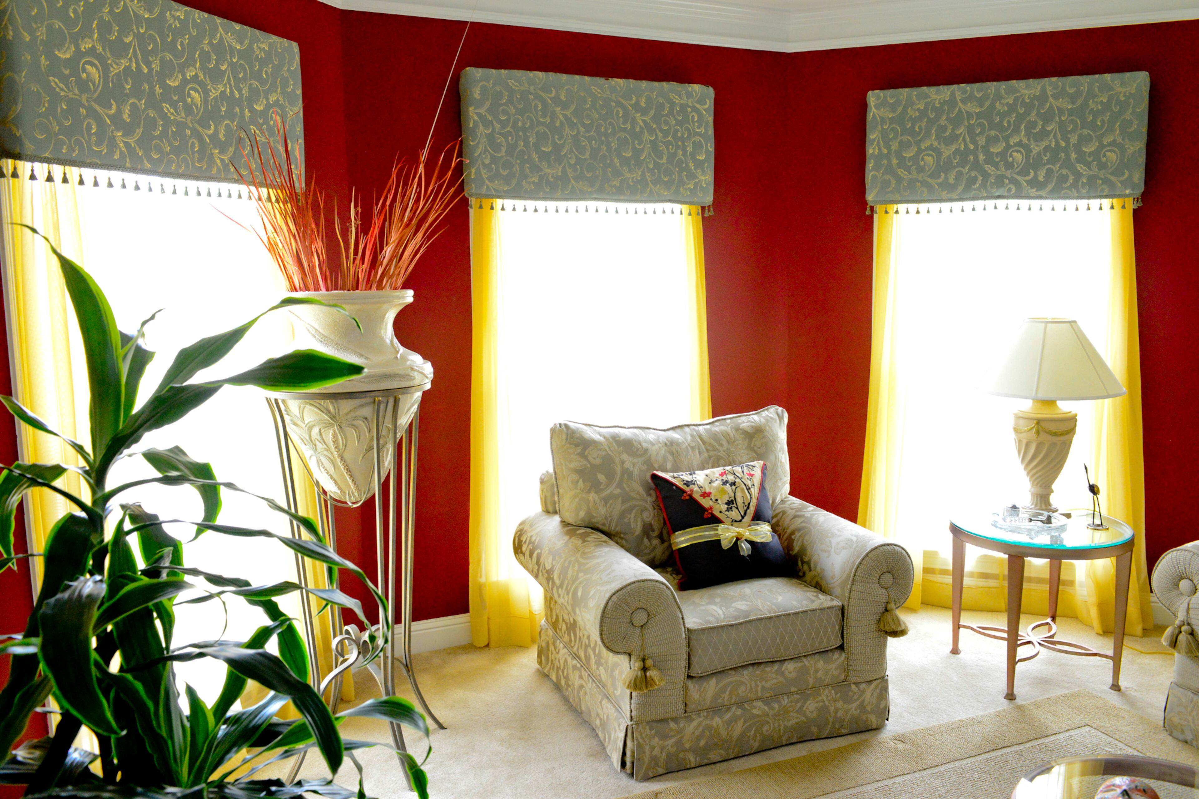 Homeowner Frances Pace designed and created the cornice boards and drapes that cover the floor-to-ceiling windows in the living room. The furniture is from Haverty's, and Pace uses floral arrangements throughout to bring more color into the house.