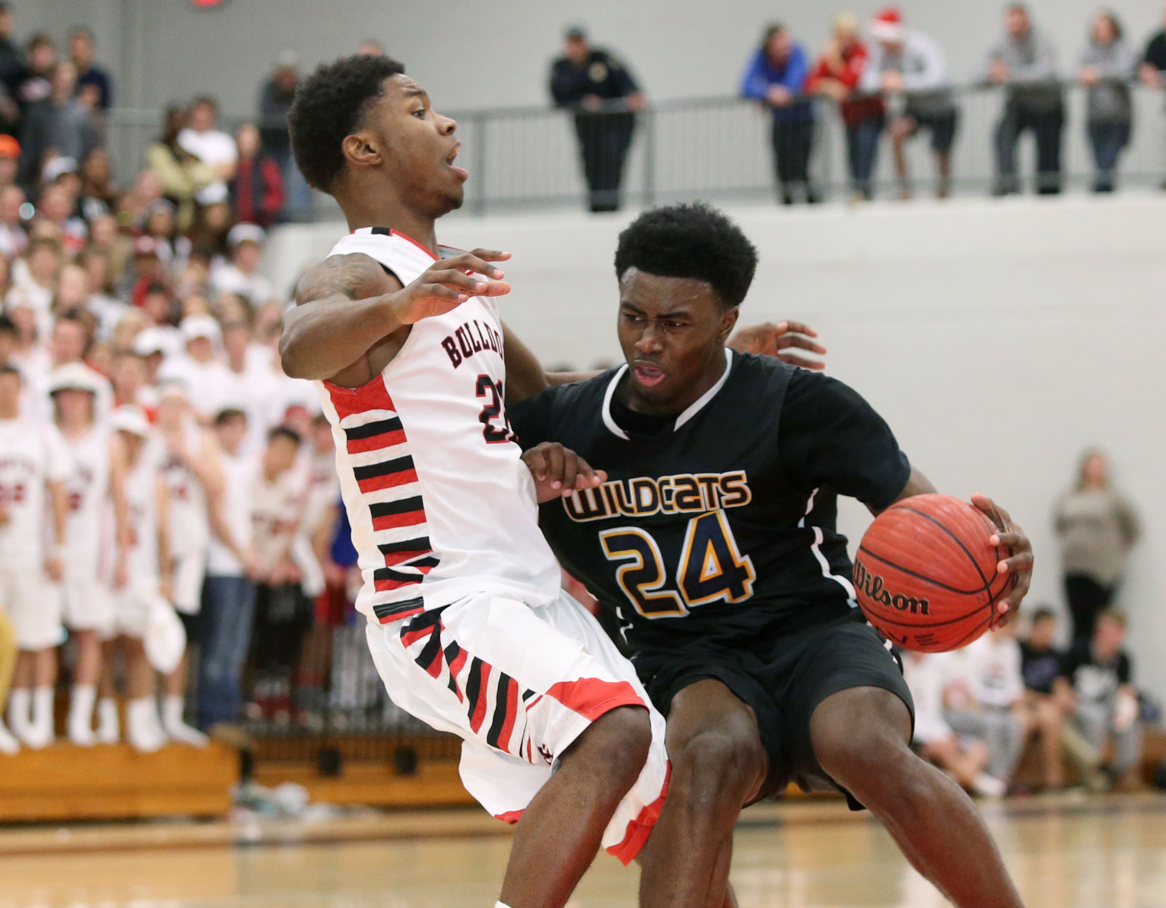 Wheeler's Jaylen Brown (24) drives against North Gwinnett's Kamaran Calhoun, left, in their game in Suwanee on Feb. 27, 2014. Brown had 20 points in the game. JASON GETZ / SPECIAL