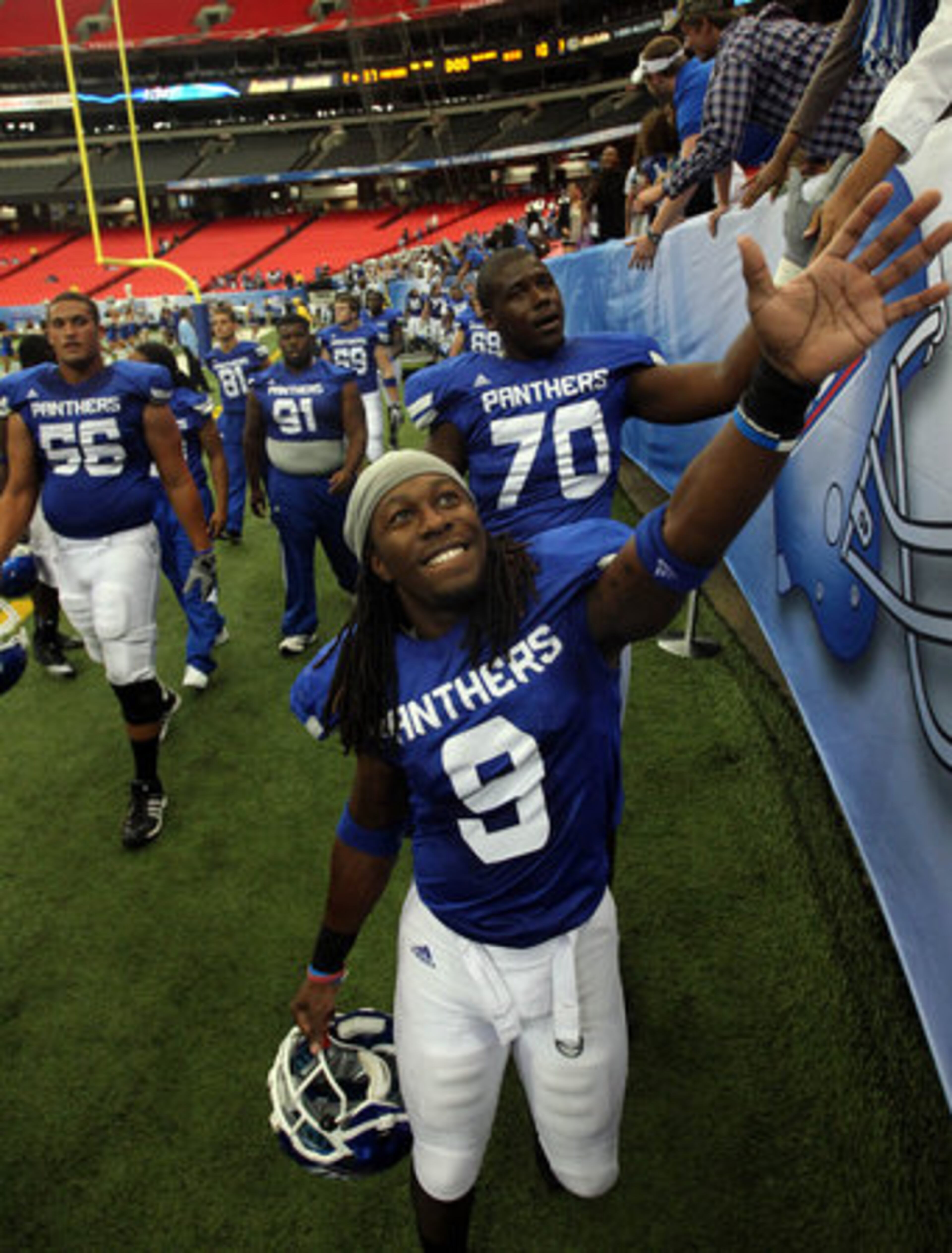 Georgia State University cornerback Brent McClendon (9) and lineman Ramell Davis (70) greet fans as they celebrate their 37-10 win over Morehead State at the Georgia Dome Saturday afternoon in in Atlanta, Ga., Oct. 2, 2010.