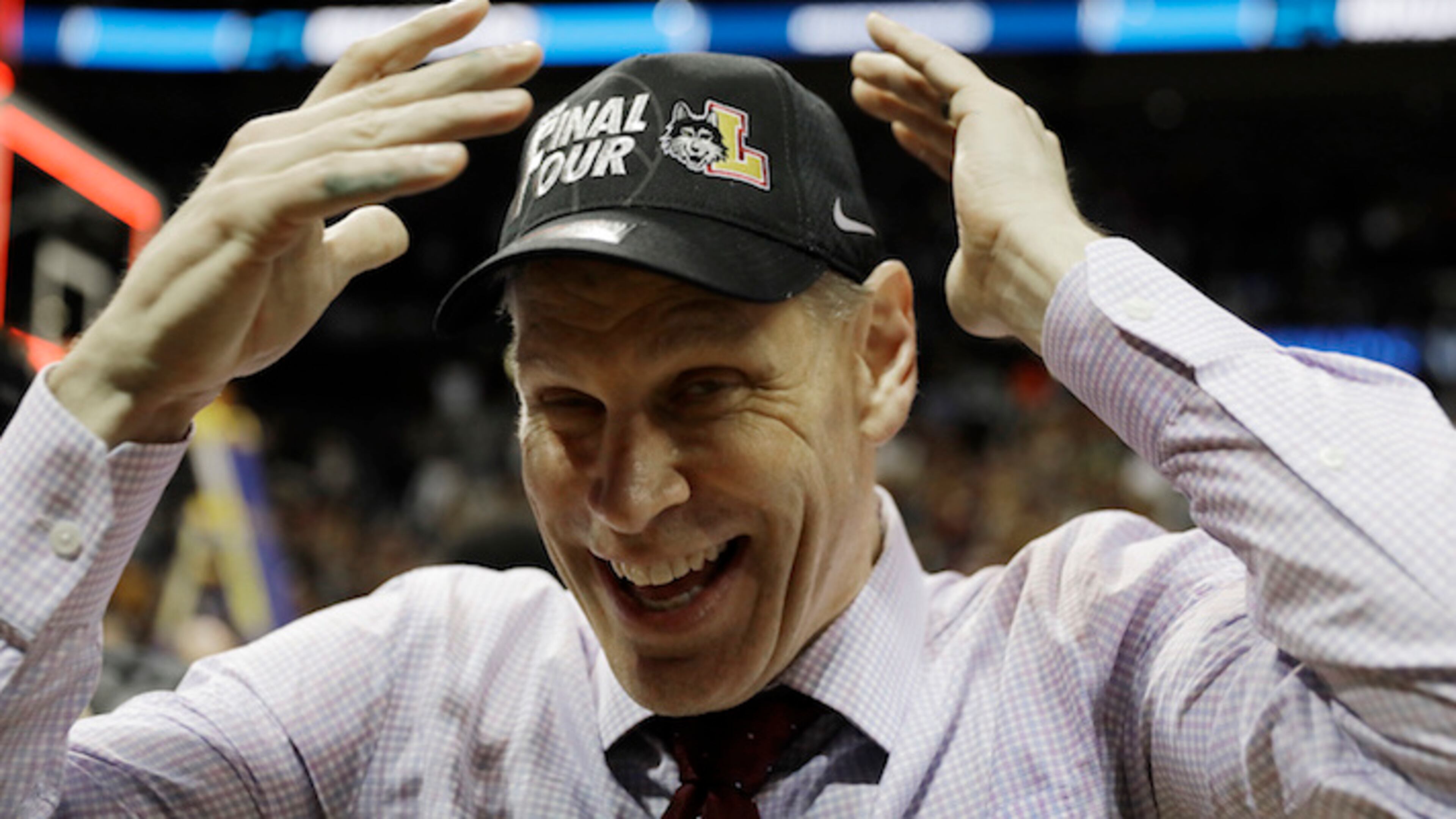 Loyola-Chicago head coach Porter Moser puts on a cap after a regional final NCAA college basketball tournament game against Kansas State, Saturday, March 24, 2018, in Atlanta. Loyola-Chicago won 78-62. (AP Photo/David Goldman)