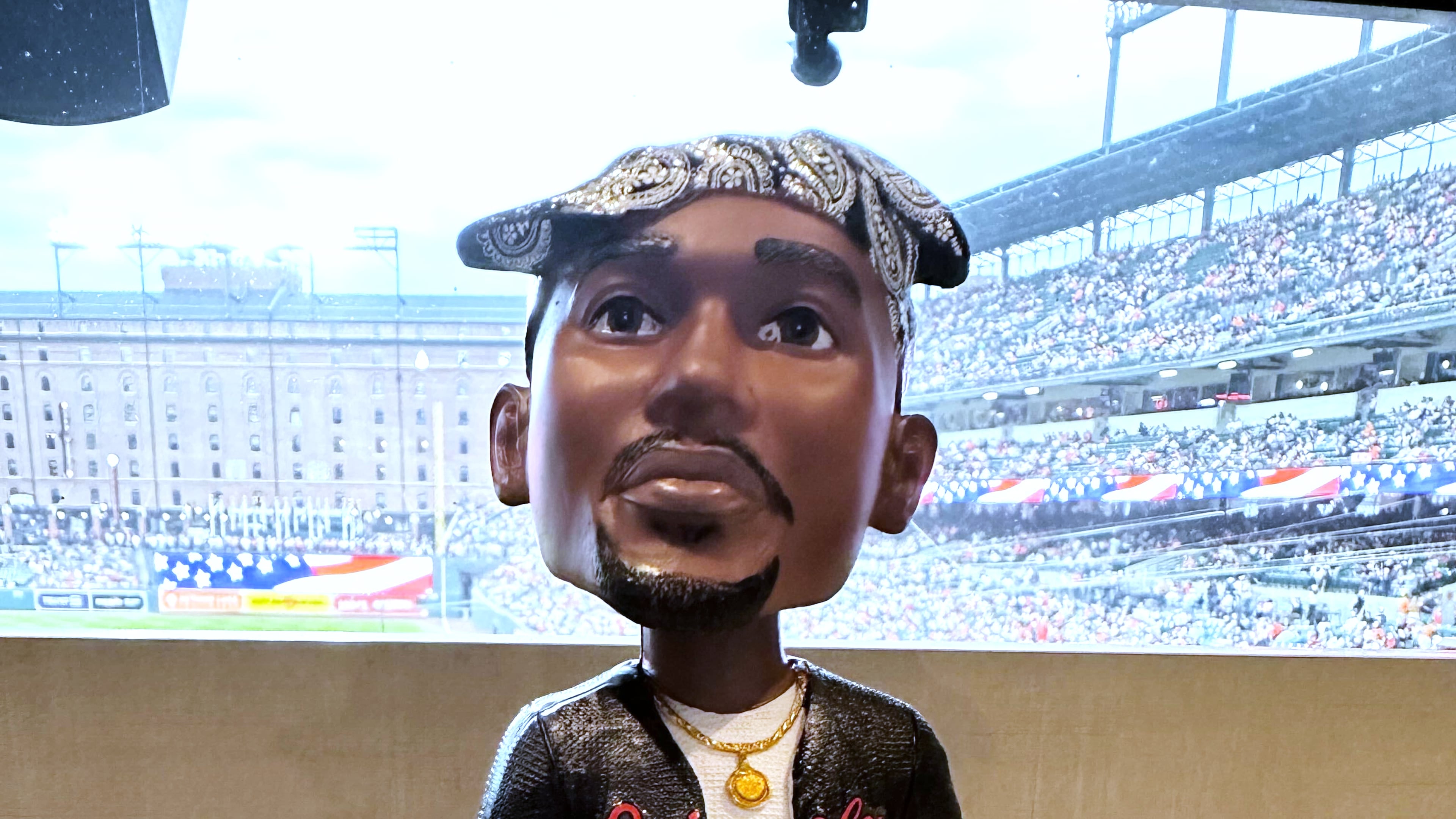 A Tupac Shakur bobblehead is displayed for the Baltimore Orioles' giveaway at a baseball game against the Athletics on Friday, May 8, 2026, in Baltimore. (AP Photo/Noah Trister)