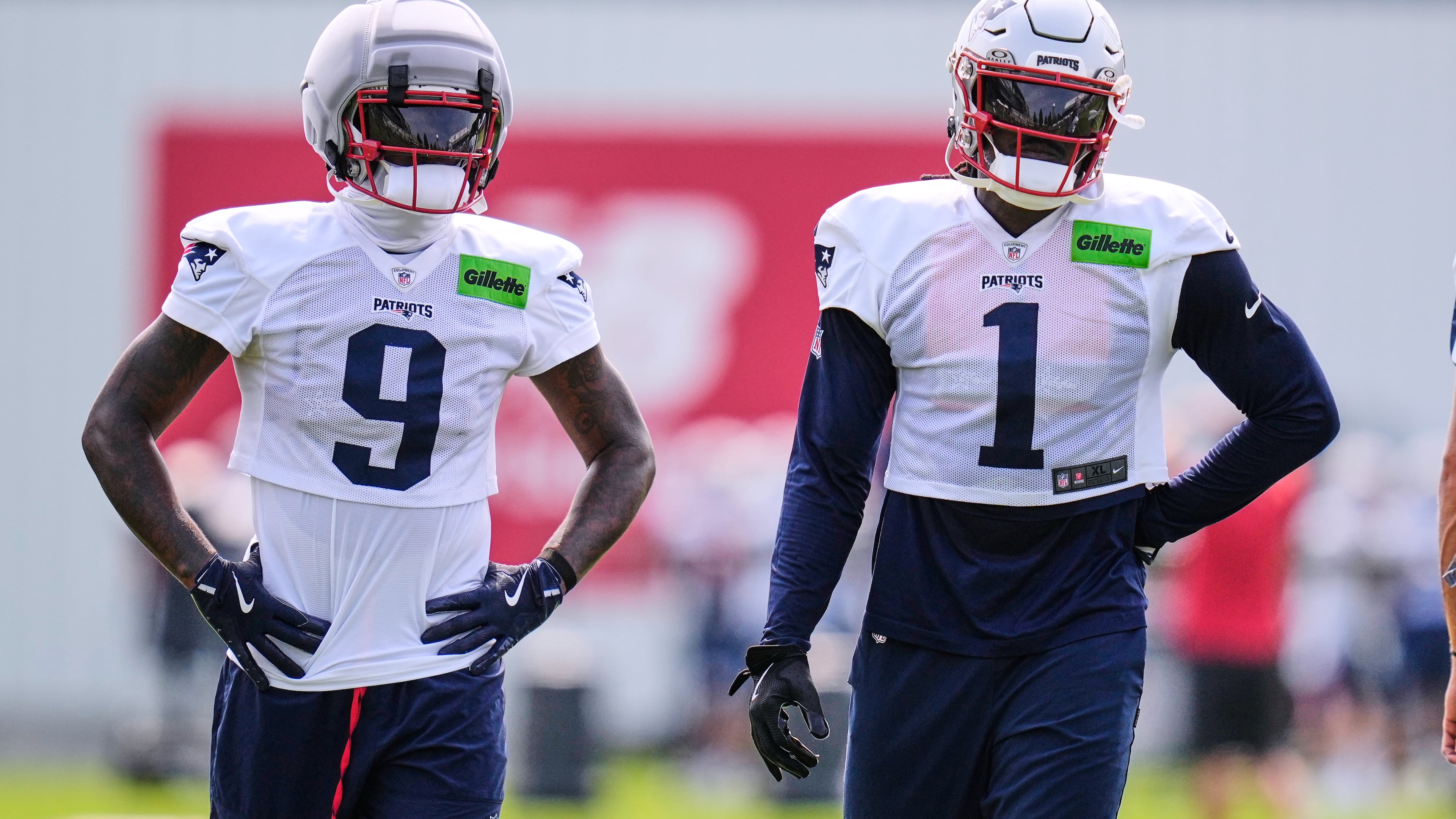New England Patriots wide receivers A.J. Brown (1) and Kayshon Boutte (9) wait their turn on a drill during the team's NFL football training camp, Monday, Aug. 10, 2026, in Foxborough, Mass. (AP Photo/Charles Krupa)