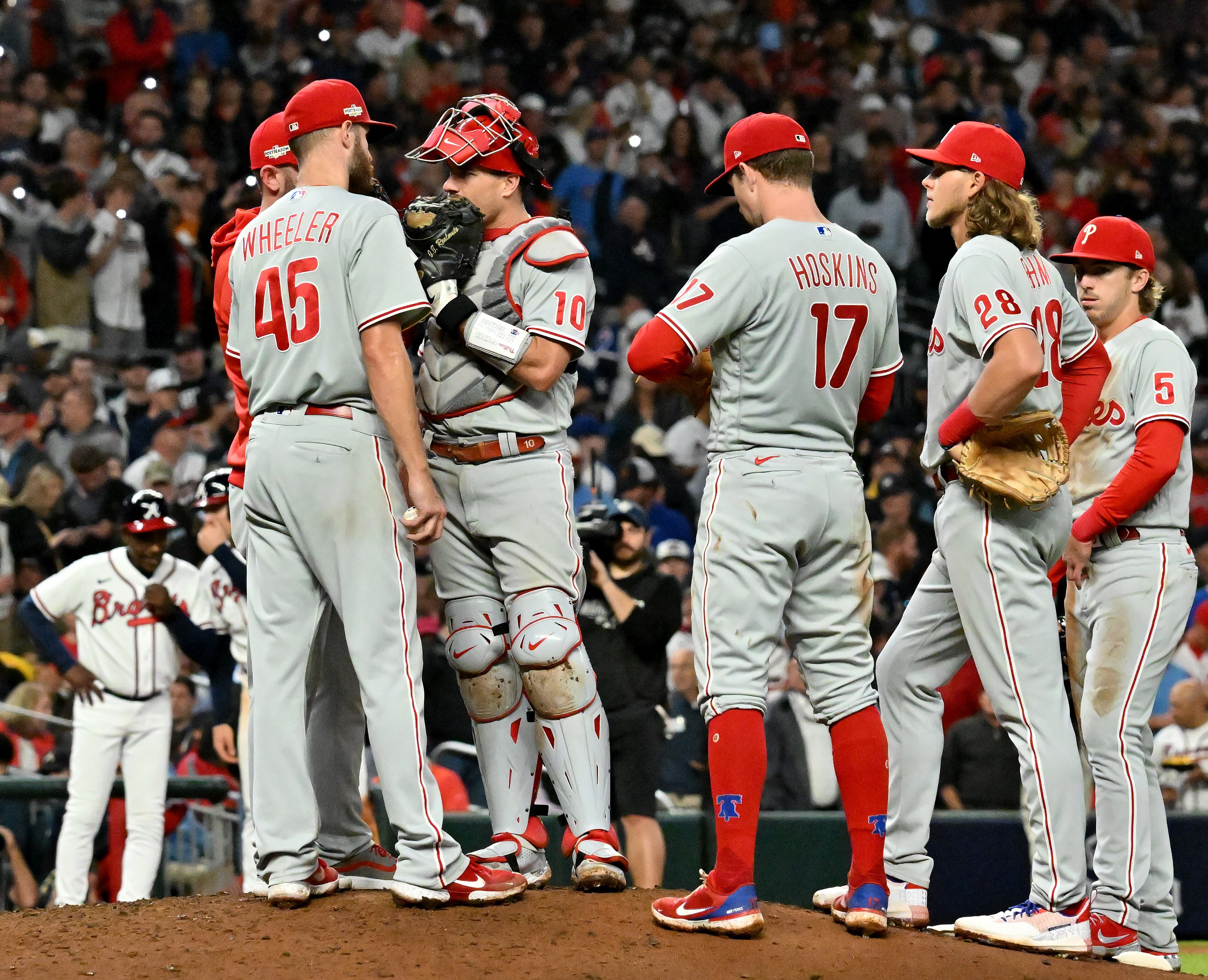 Philadelphia Phillies starting pitcher Zack Wheeler (45) huddles on the pitching mound after giving up three runs to the Atlanta Braves during the sixth inning of game two of the National League Division Series at Truist Park in Atlanta on Wednesday, October 12, 2022. (Hyosub Shin / Hyosub.Shin@ajc.com)
