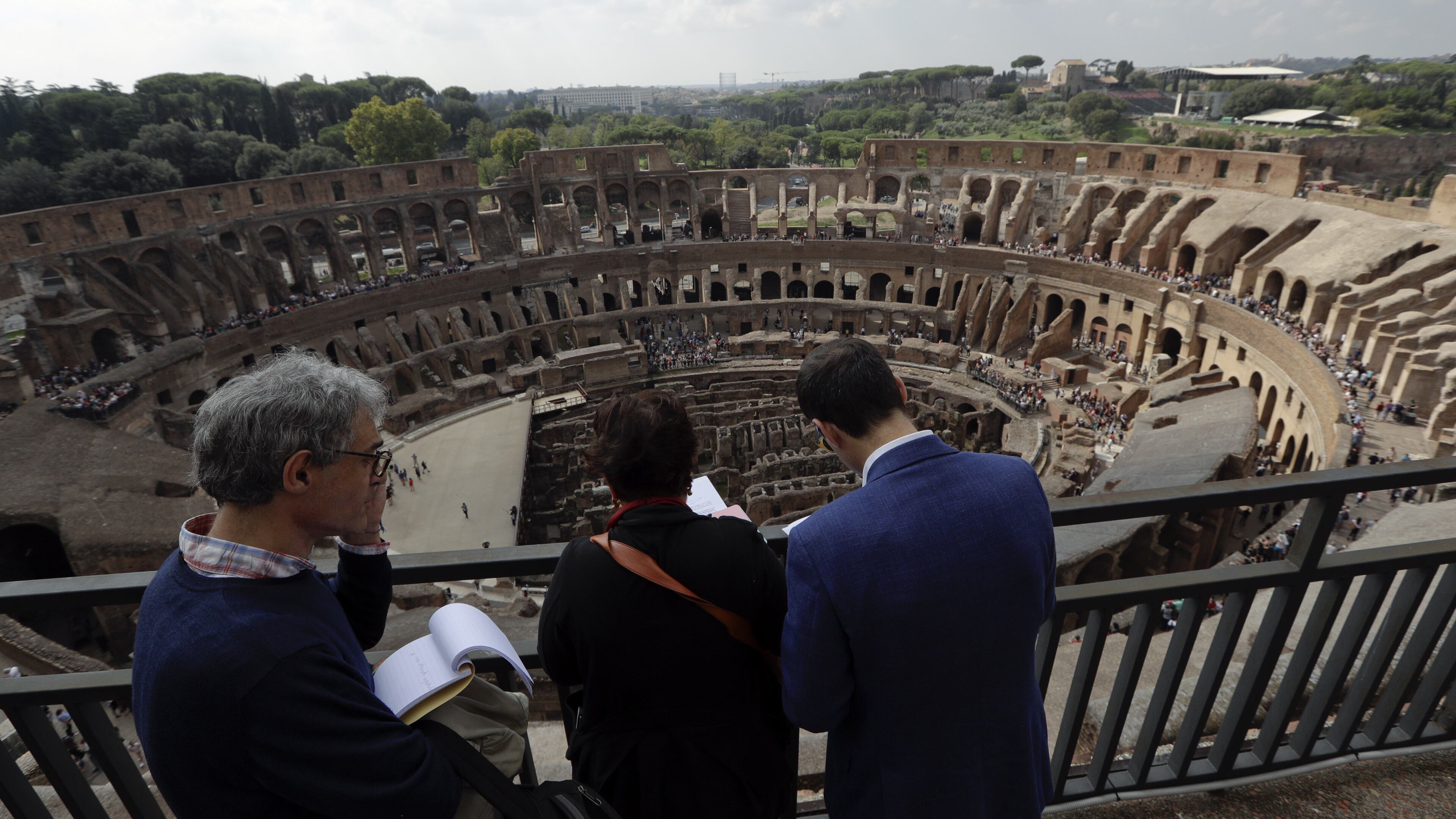 Journalists looks out from topmost level of the ancient Colosseum on the occasion of a media tour presenting the re-opening after forty years of the fourth and fifth level of the Italy's most famous site, in Rome, Tuesday, Oct. 3, 2017. Italian Culture Minister Dario Francheschini was on hand Tuesday to tour the new levels, which during ancient Roman times were the cheapest seats, reserved for the plebes because they were farther away from the spectacle and exposed to Rome's harsh sun. (AP Photo/Andrew Medichini)