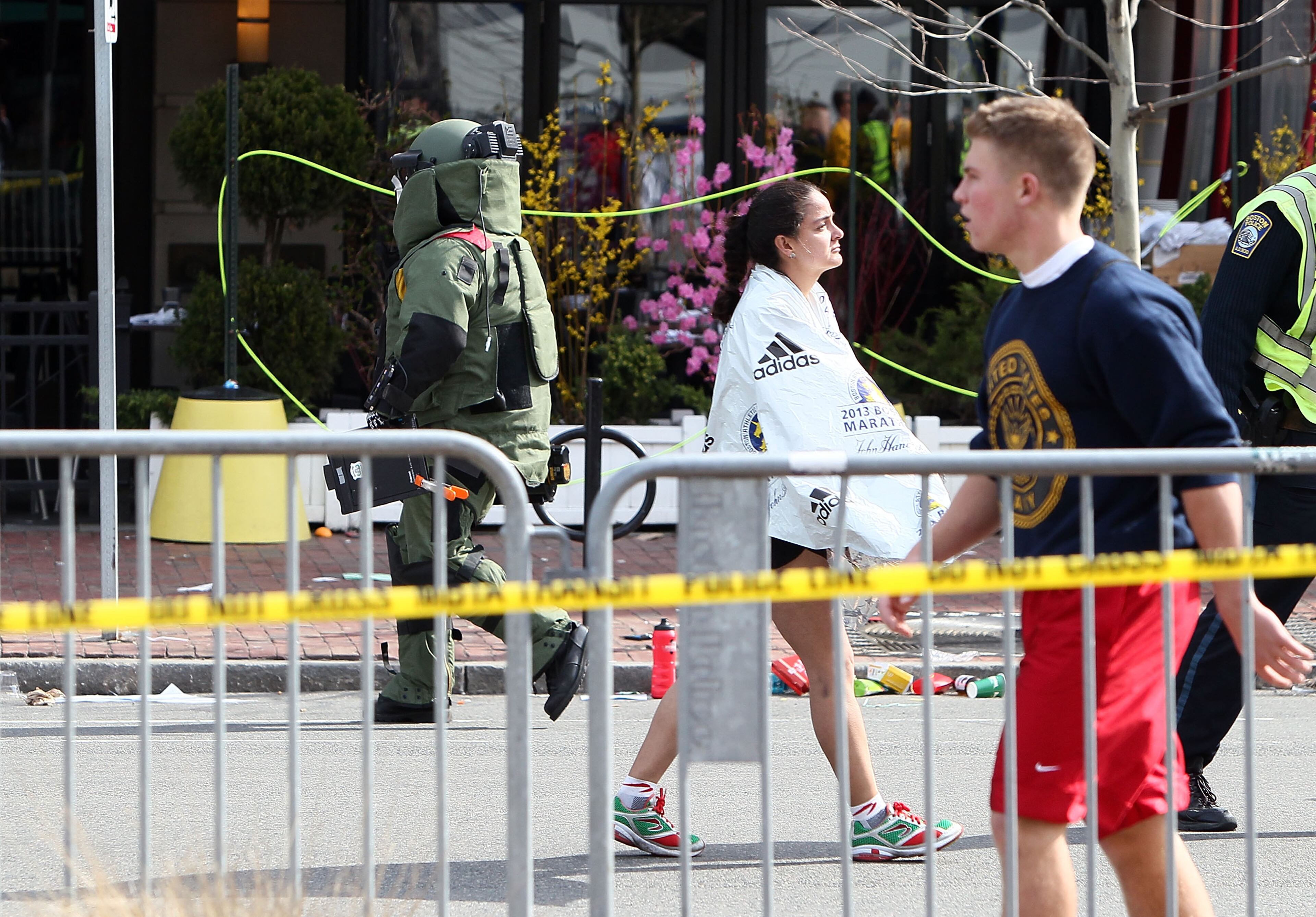 BOSTON, MA - APRIL 15: A member of the bomb squad investigates a suspicious item on the road near Kenmore Square after two bombs exploded during the 117th Boston Marathon on April 15, 2013 in Boston, Massachusetts. Two people are confirmed dead and at least 23 injured after two explosions went off near the finish line to the marathon. (Photo by Alex Trautwig/Getty Images)