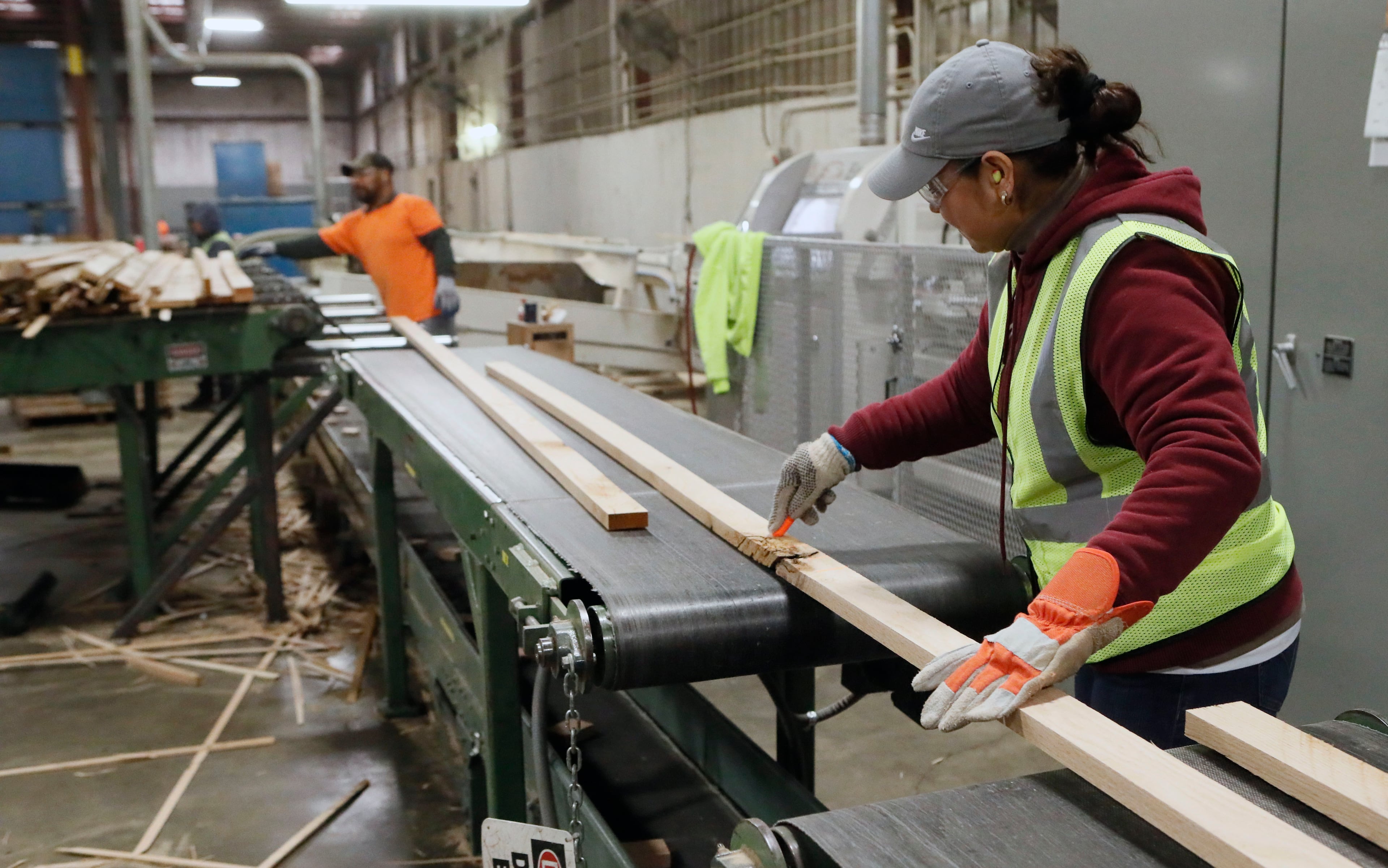 November 14, 2019 -Cleveland, GA - A worker marks defects, which will be cut out, in strips of oak that is destined to become handrailing. Jim Howard's Atlanta family business of buying and selling hardwood grew since the Great Recession on the strength of exports mostly to China, whose growing middle class wanted red oak floors and white oak furniture. When the trade war resulted in 25% Chinese tariffs on American wood, Howard's growing export business fell from 25% of company income to 8% in a year. Bob Andres / robert.andres@ajc.com