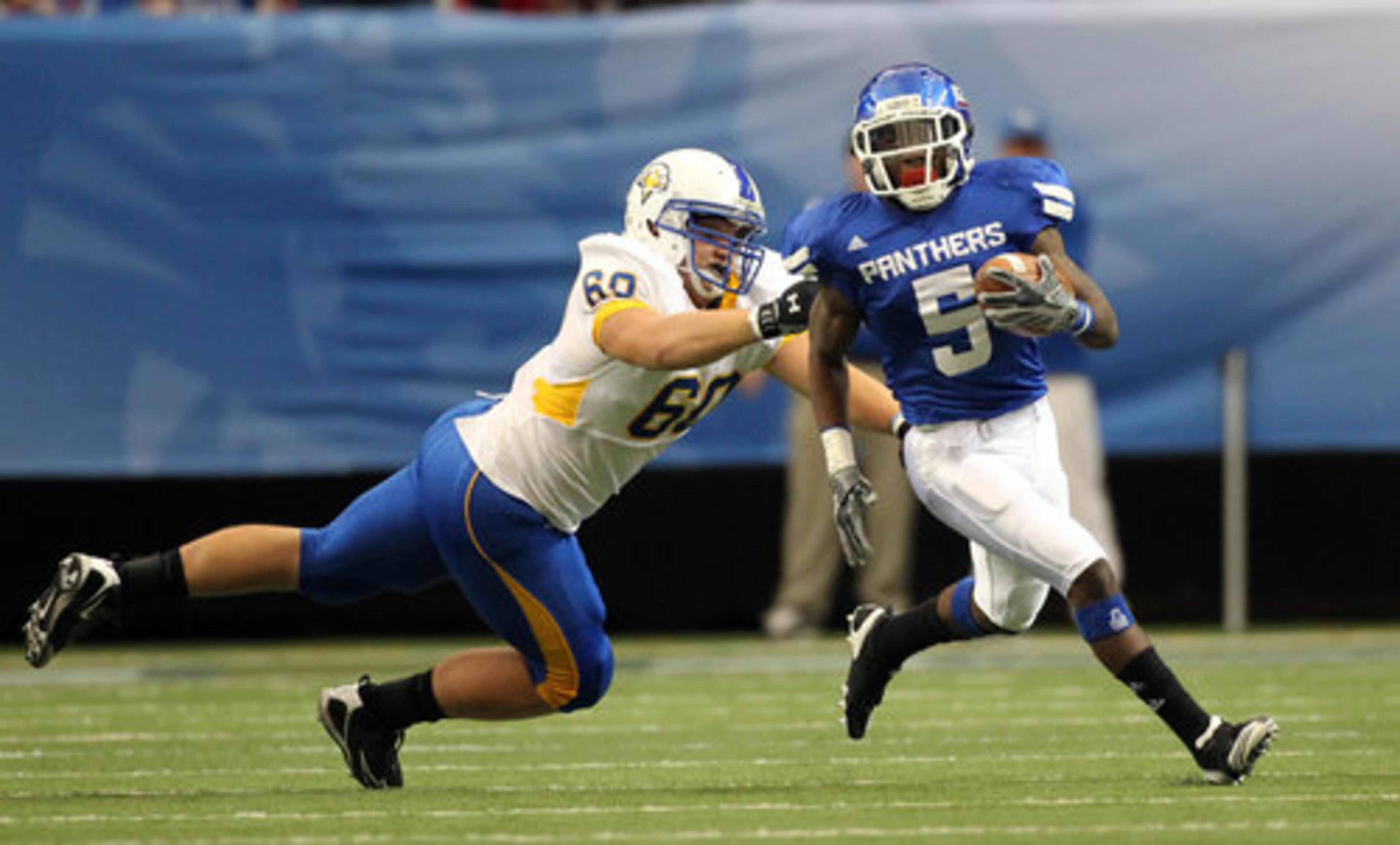 Georgia State University punt returner Demarius Matthews (5) gets past the tackle of Morehead State defender Aaron Meadows on a long punt return in the first half of their game at the Georgia Dome Saturday afternoon in in Atlanta, Ga., Oct. 2, 2010. GSU defeated Morehead State 37-10.