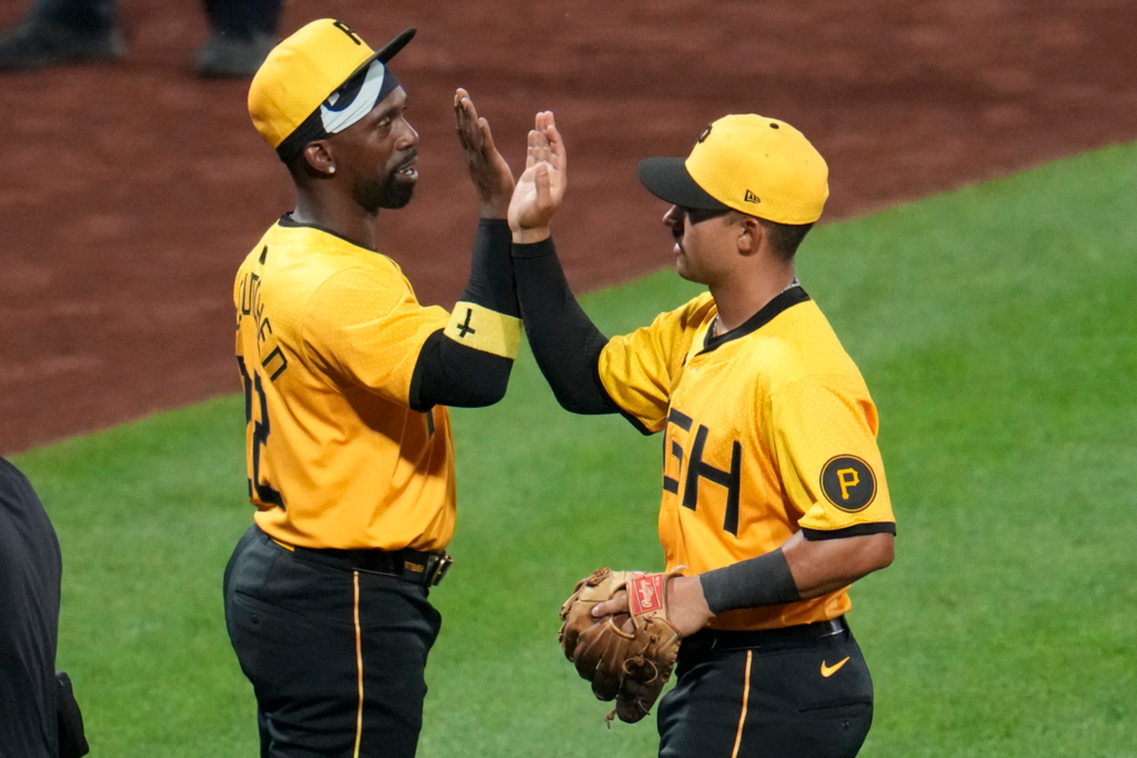 Pittsburgh Pirates' Nick Gonzales, right, celebrates with Andrew McCutchen after the team's baseball game against the Atlanta Braves in Pittsburgh, Friday, May 24, 2024. The Pirates won 11-5. (AP Photo/Gene J. Puskar)