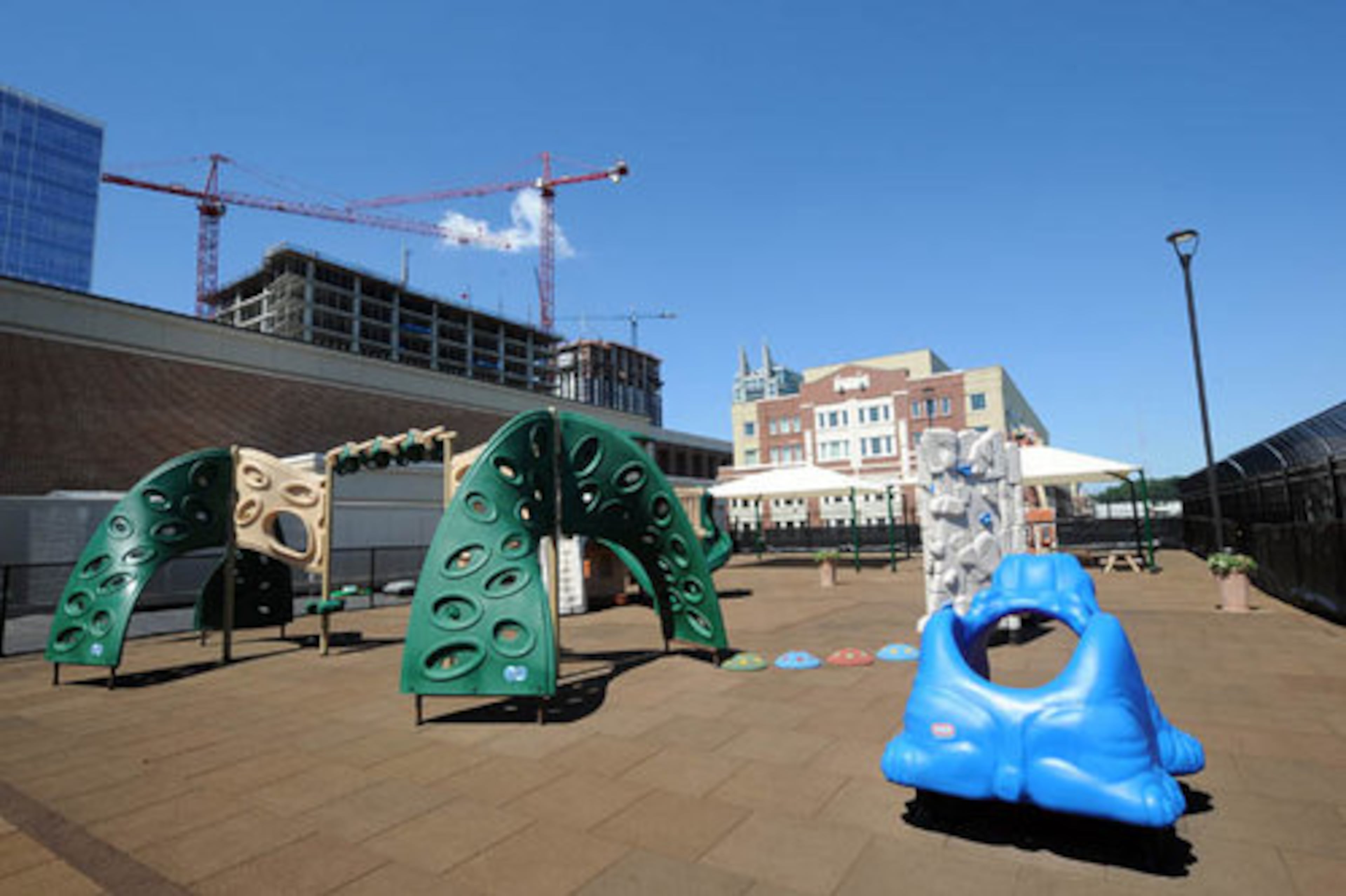 The rooftop playground includes slides, swings, wooden doll house, bubbling brick fountains and wind chimes. The soft ground was made with recycled materials.