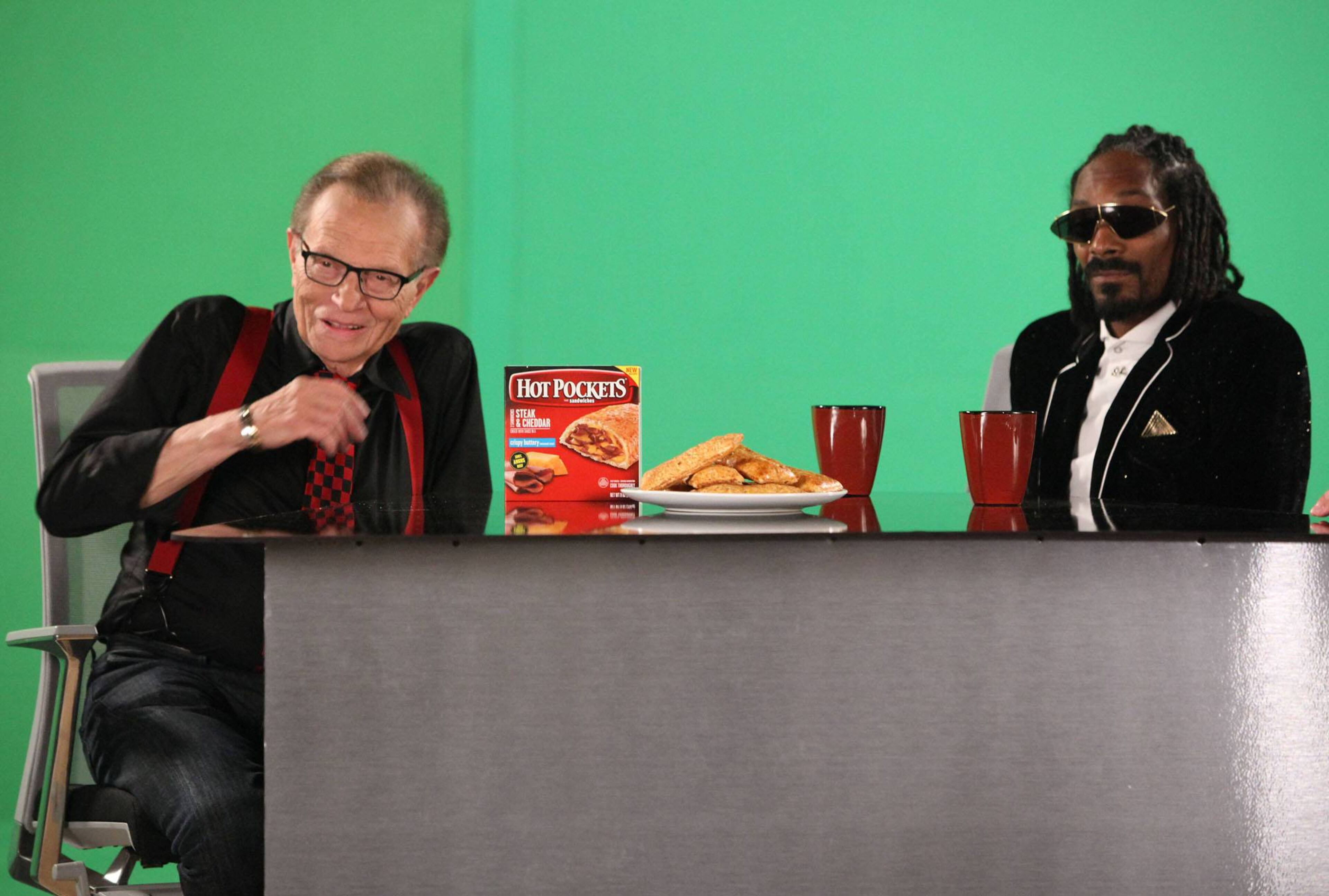 Snoop Dogg and Larry King are seen on the set of the "You Got What I Eat" music video in Los Angeles in October 2013.