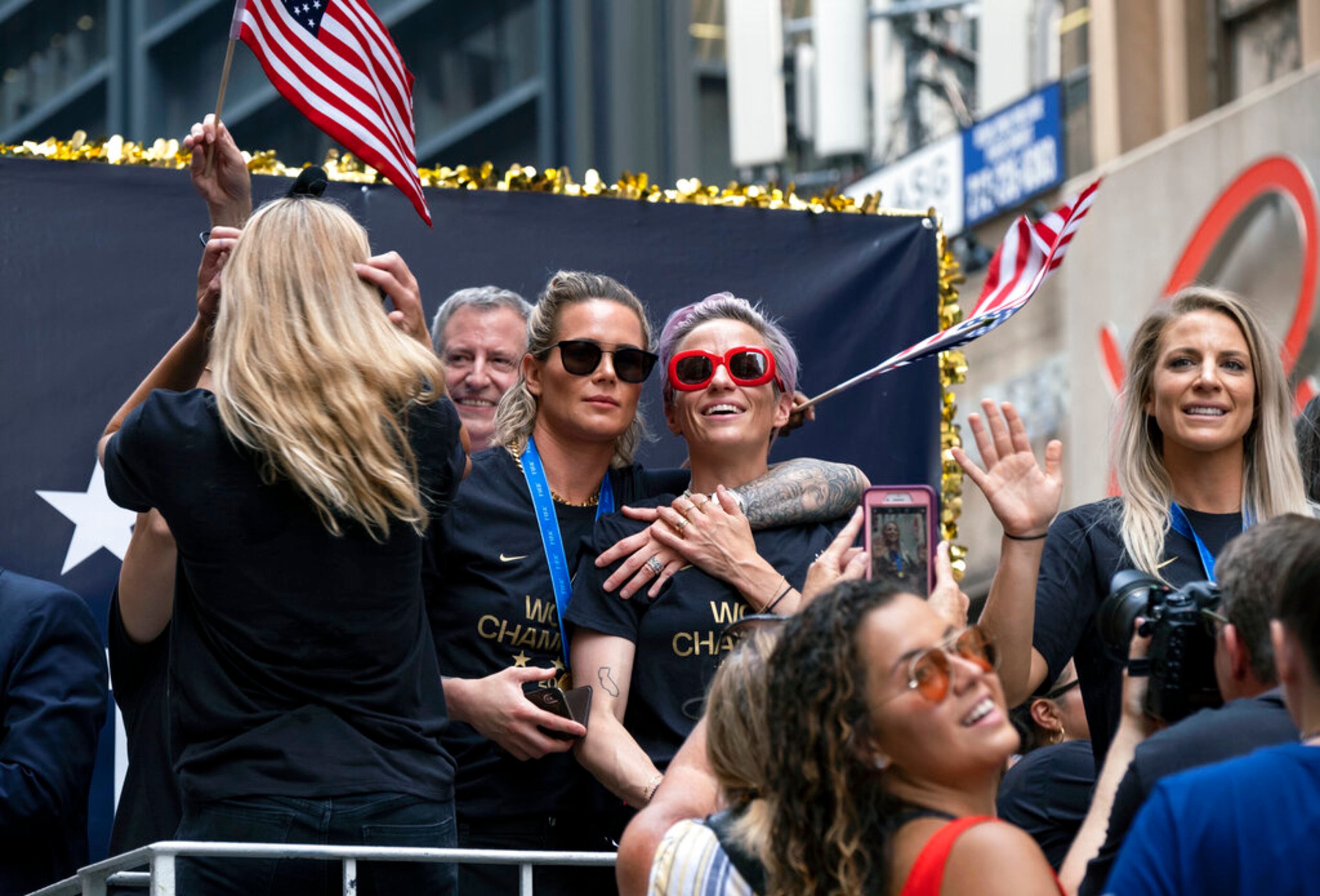 Members of the U.S. women's soccer team, including Megan Rapinoe, center and Julie Ertz, at right waving, celebrates during a ticker tape parade along the Canyon of Heroes, Wednesday, July 10, 2019, in New York. The U.S. national team beat the Netherlands 2-0 to capture a record fourth Women's World Cup title. (AP Photo/Craig Ruttle)