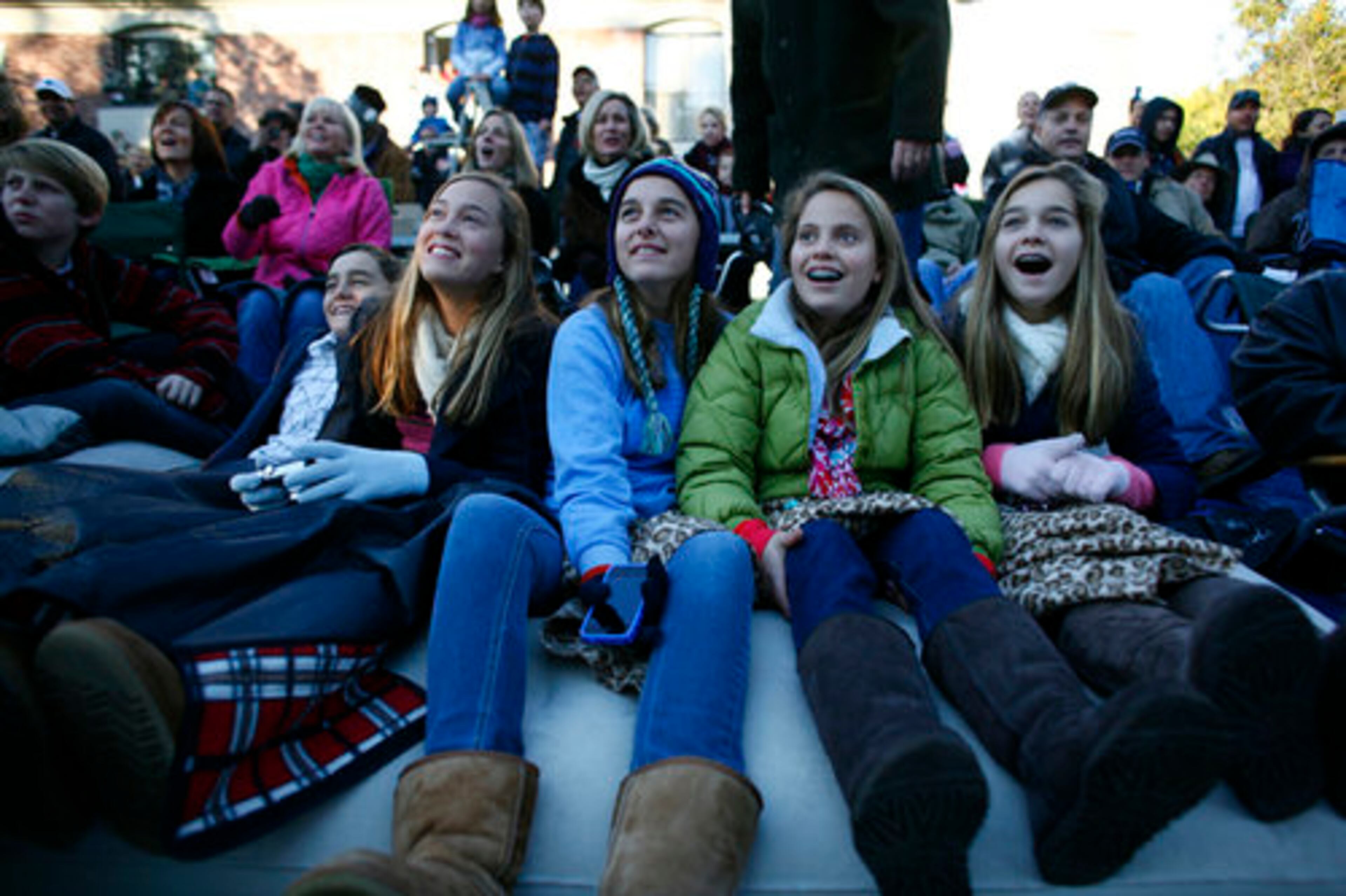 Matthew Johnson, (from left) Natalie Johnson, Juliet Johnson, Perry Hotchkis, and Sarah Johnson, watch in awe as the parade floats make their way past their viewing spot.