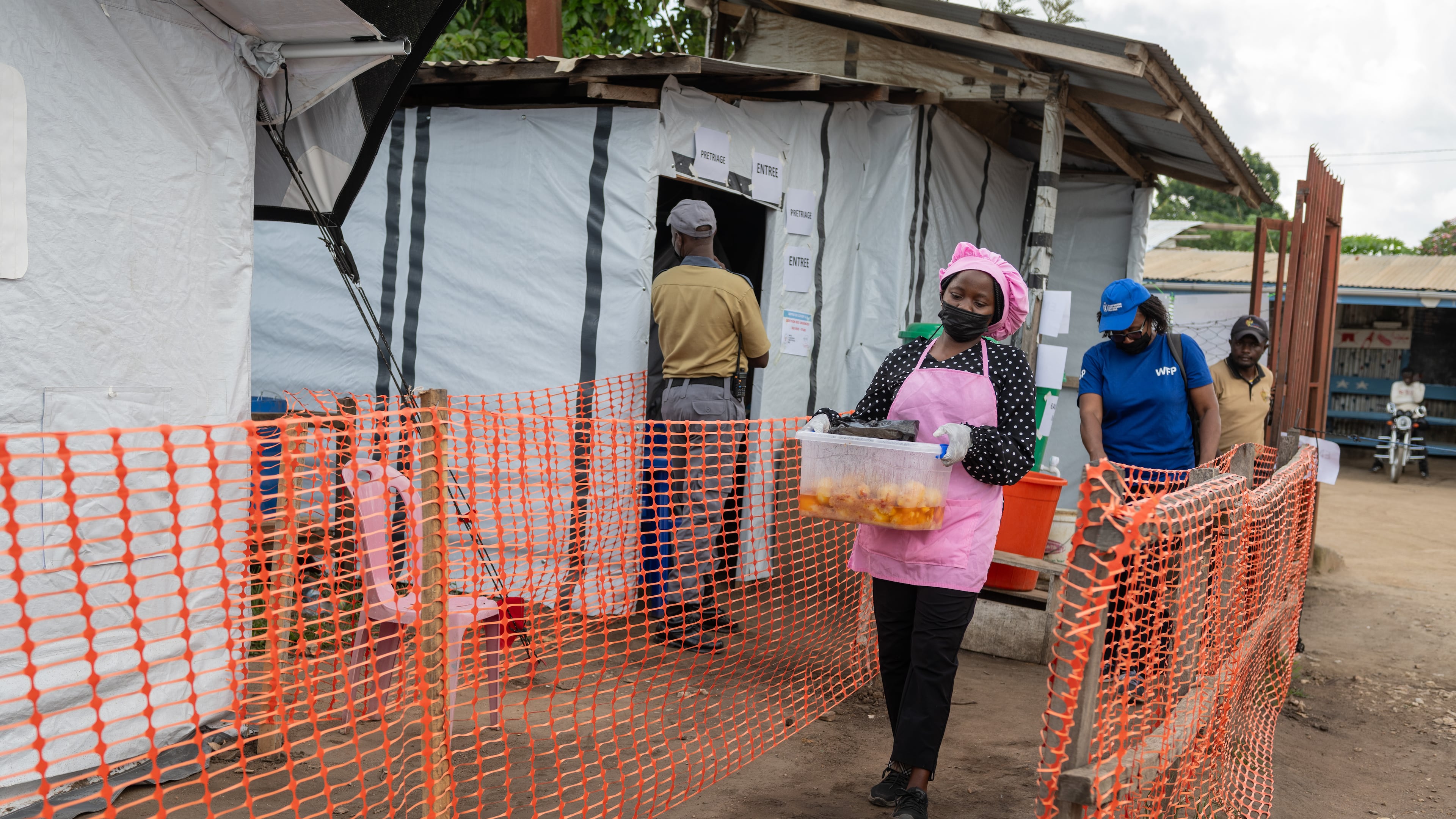 Kavugho Hortense, a cook, delivers meals to the medical staff and Ebola patients at the Evangelical Medical Center (CEM) in Bunia, Congo, Monday, June 1, 2026. (AP Photo/Moses Sawasawa)