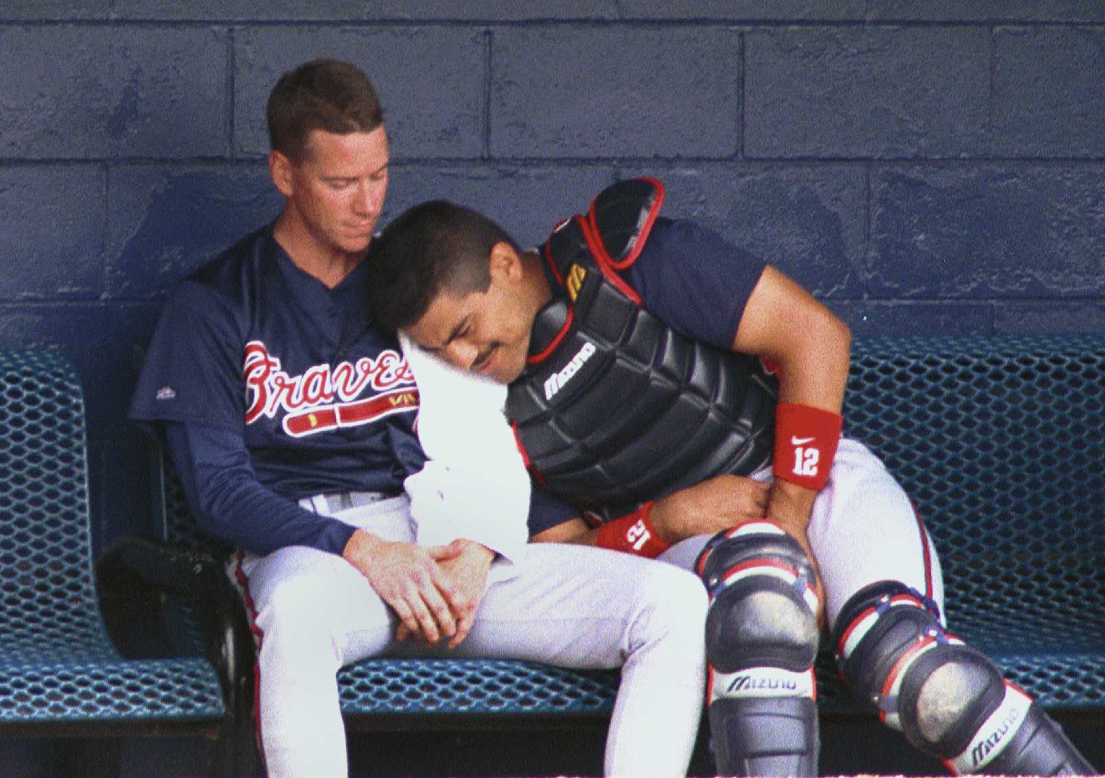 Braves catcher Eddie Perez rests his head on starting pitcher Tom Glavine's pitching arm after the fifth inning of the spring training game with the Detroit Tigers in 1999.