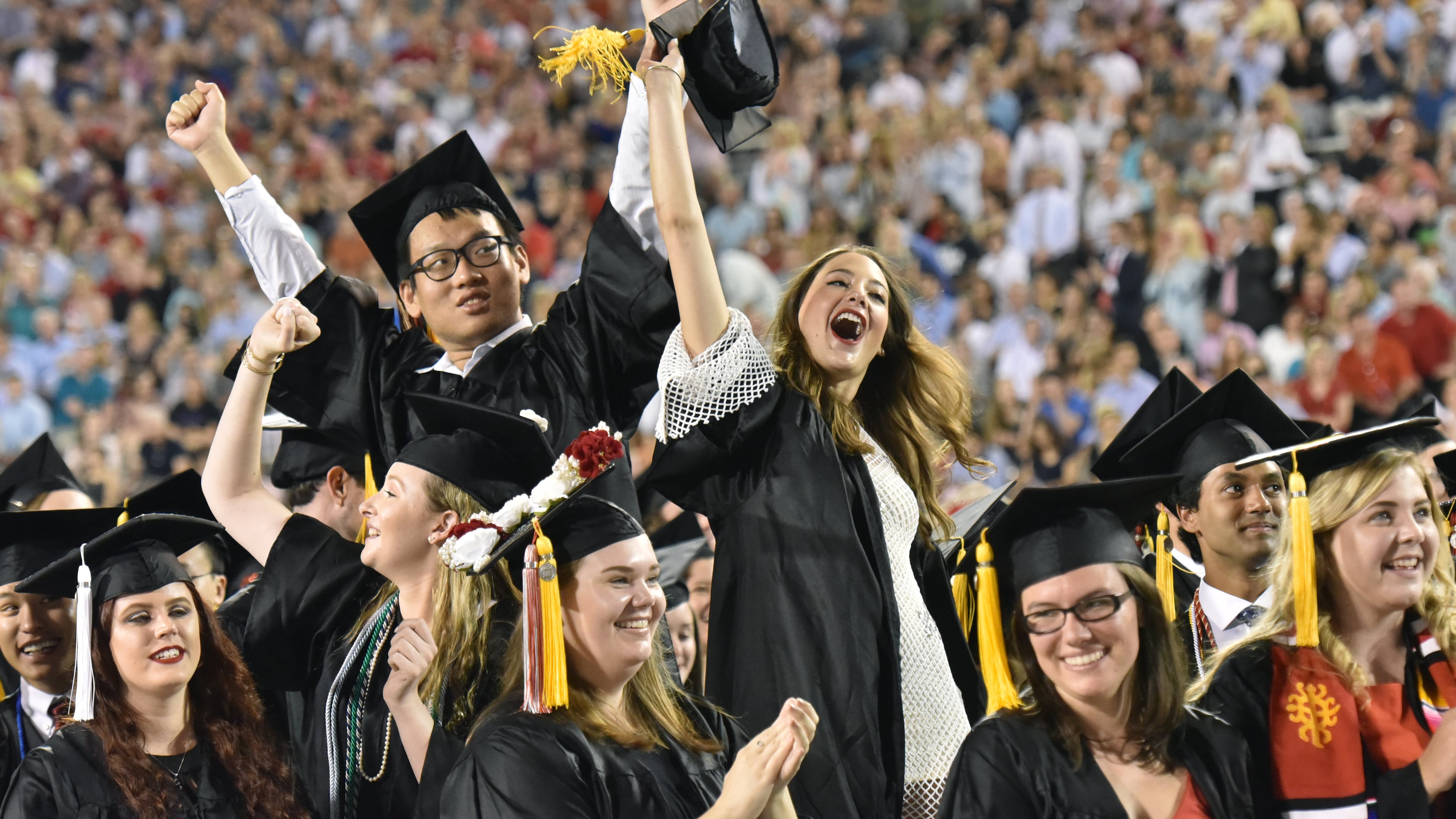 University of Georgia students cheer as they move their tassels during the 2018 spring undergraduate commencement ceremony at Sanford Stadium in Athens.