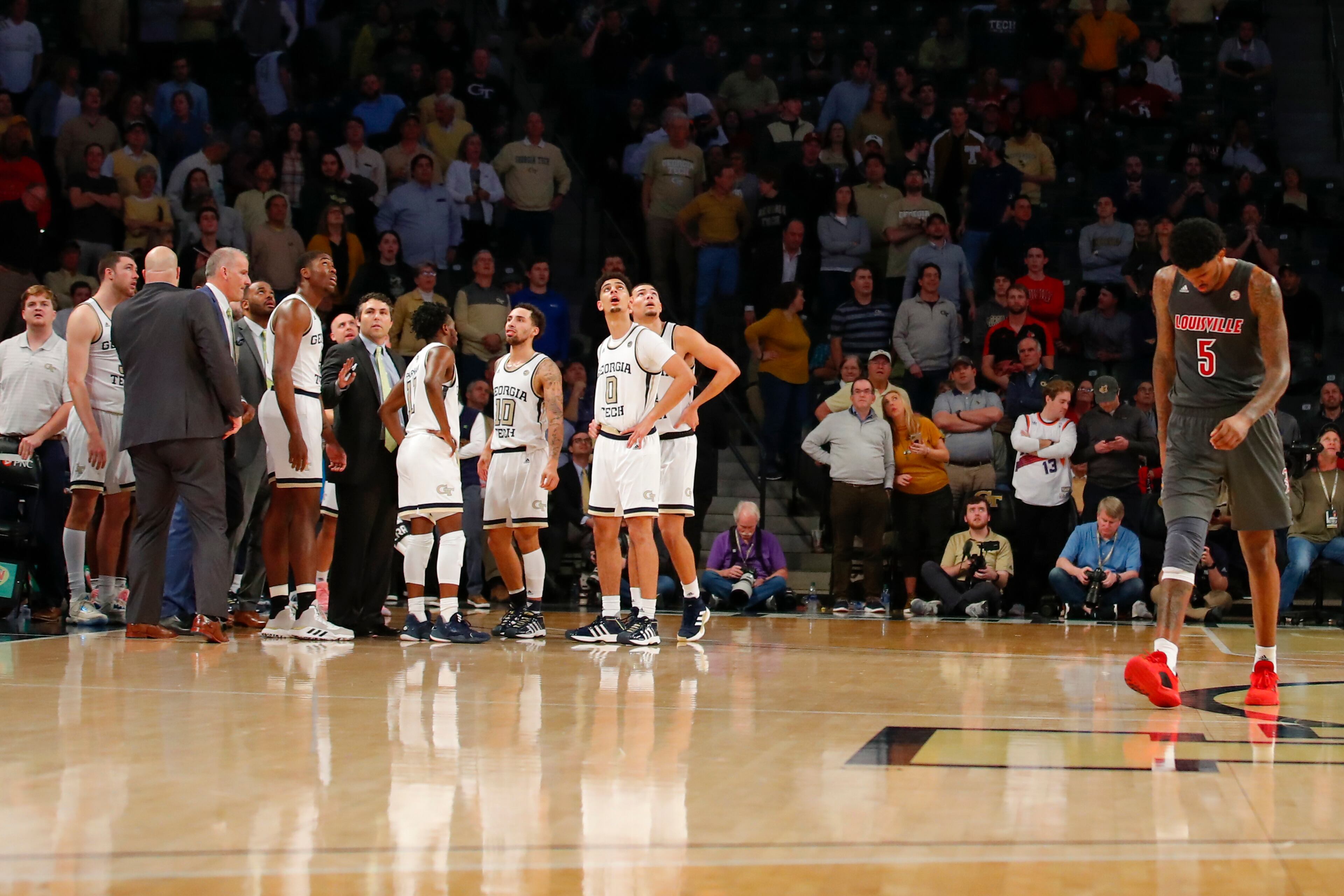 Georgia Tech players watch a replay from the bench area as Louisville forward Malik Williams (5) returns to his bench during the second half of an NCAA college basketball game in Atlanta, Wednesday, Feb. 12, 2020. (AP Photo/Todd Kirkland)