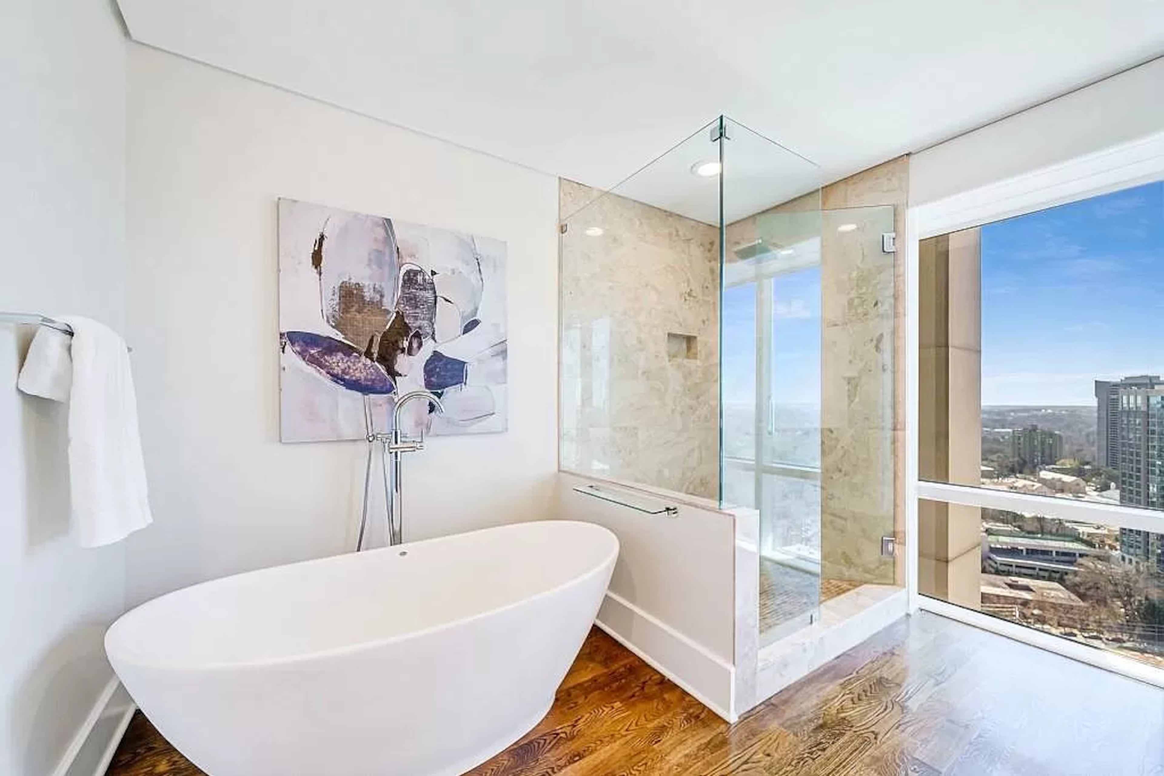 Unwind at the end of the day by taking in the twinkling city lights from the bathroom’s floor-to-ceiling windows.