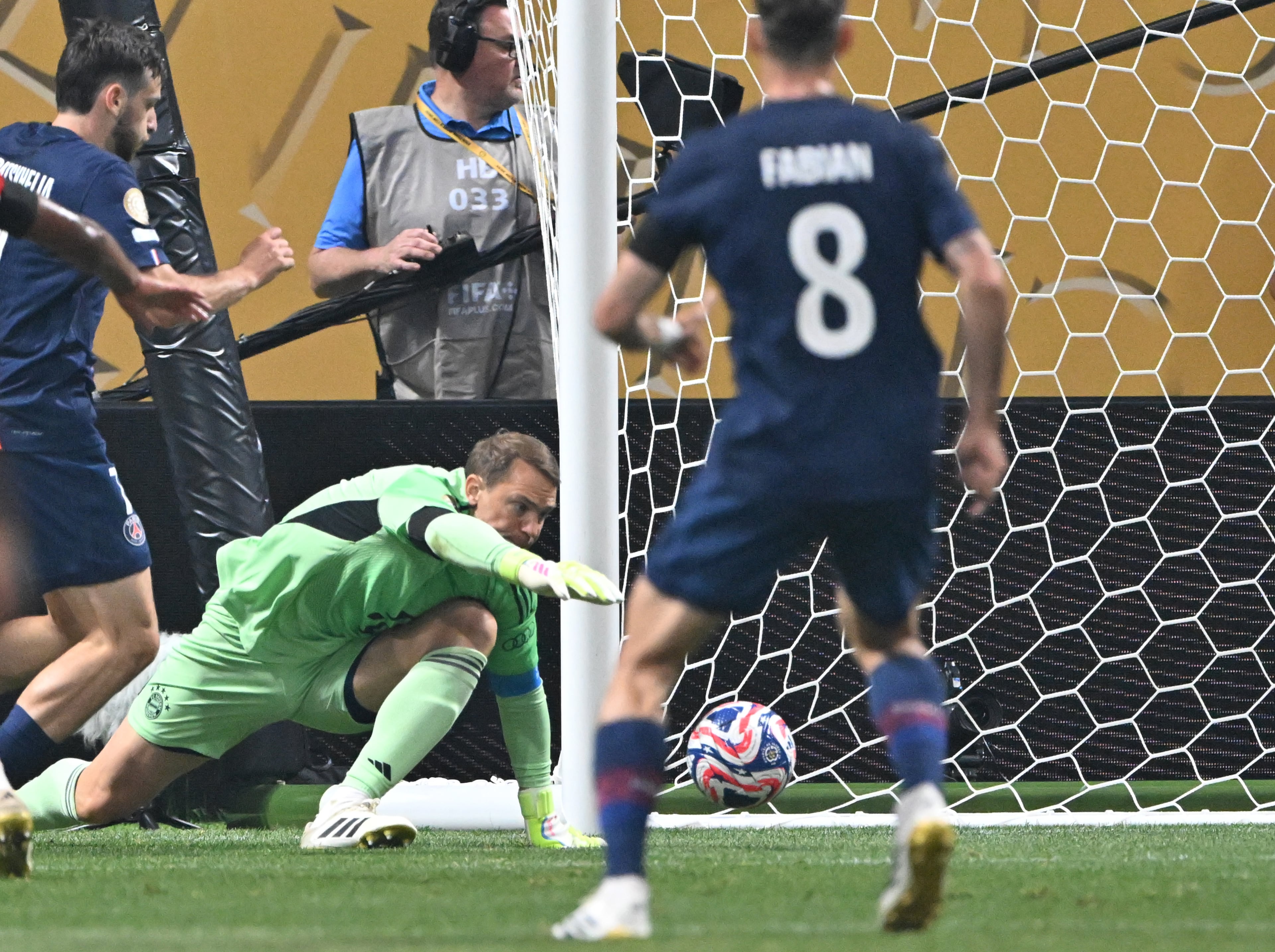 Bayern Munich goalkeeper Manuel Neuer (ground) blocks a shot by Paris Saint-Germain's Khvicha Kvaratskhelia during the first half of the Club World Cup quarterfinals match at Mercedes-Benz Stadium on Saturday, July 5, 2025, in Atlanta. (Hyosub Shin/AJC)