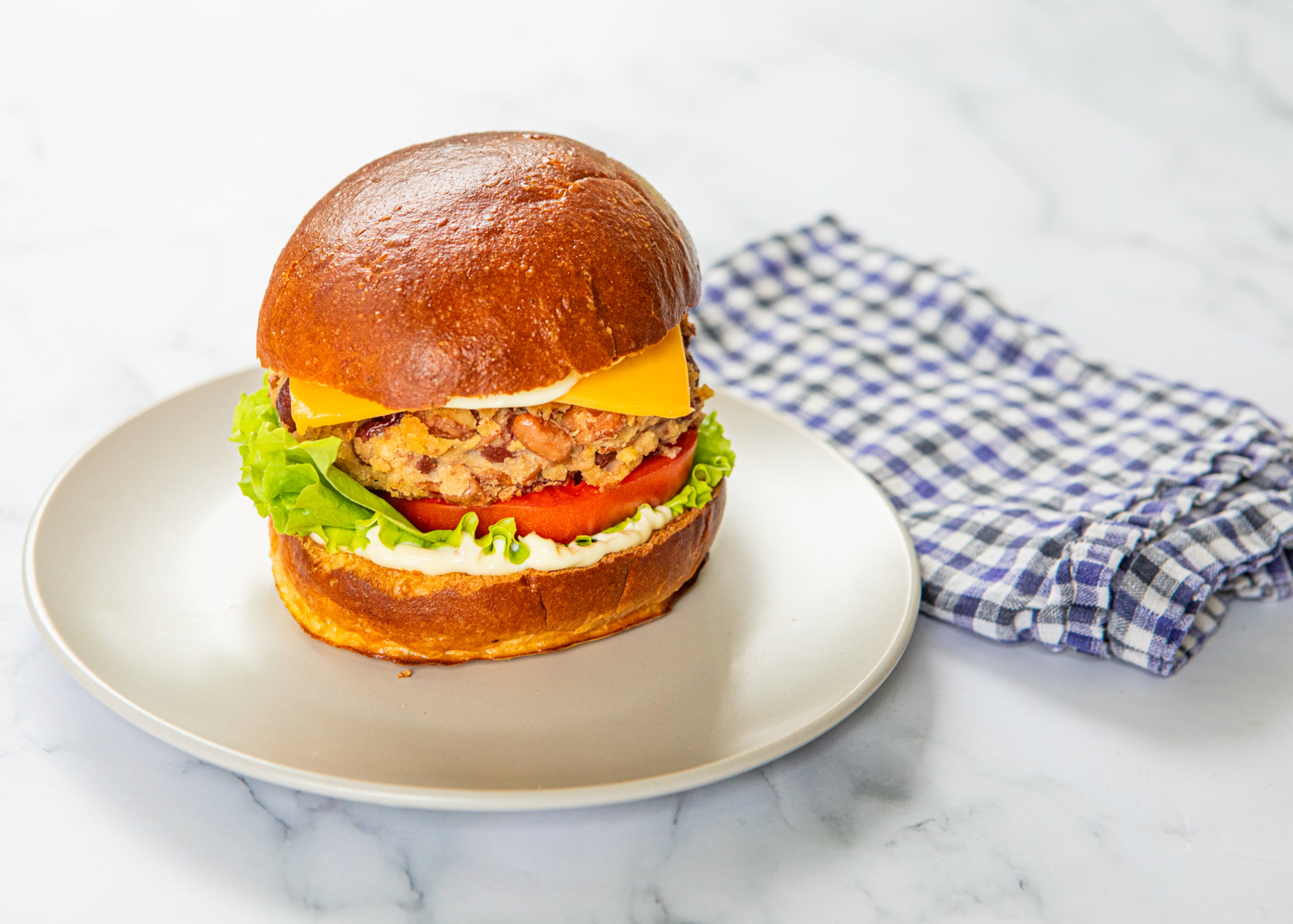 Homemade vegetarian burgers can be made from any variety of cooked beans and a handful of other simple ingredients. (Aaliyah Man for the AJC/food styling by Kate Williams)