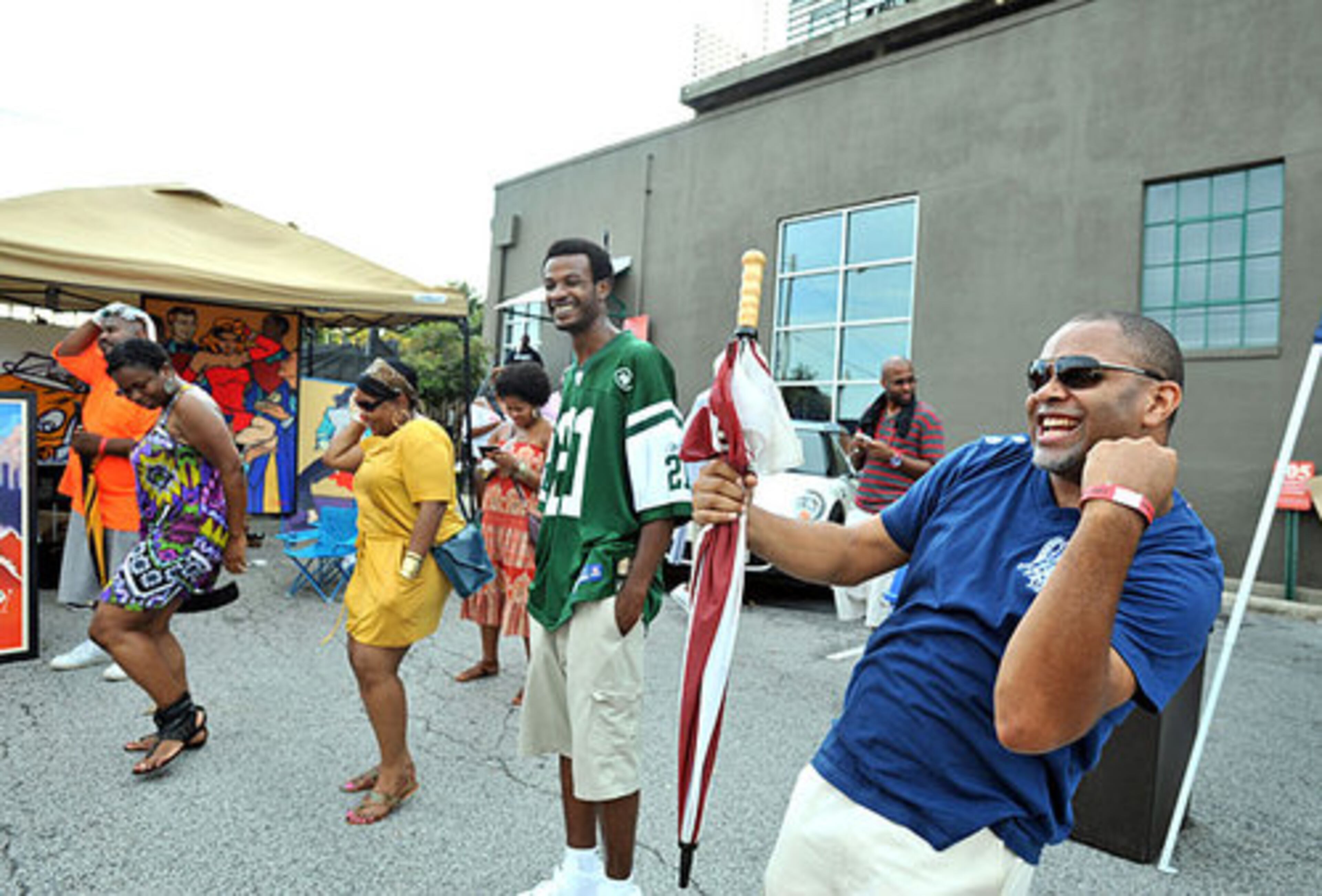 Taifeeq Nabawi (right), of Atlanta, dances to the beat created by DJ Kemit.