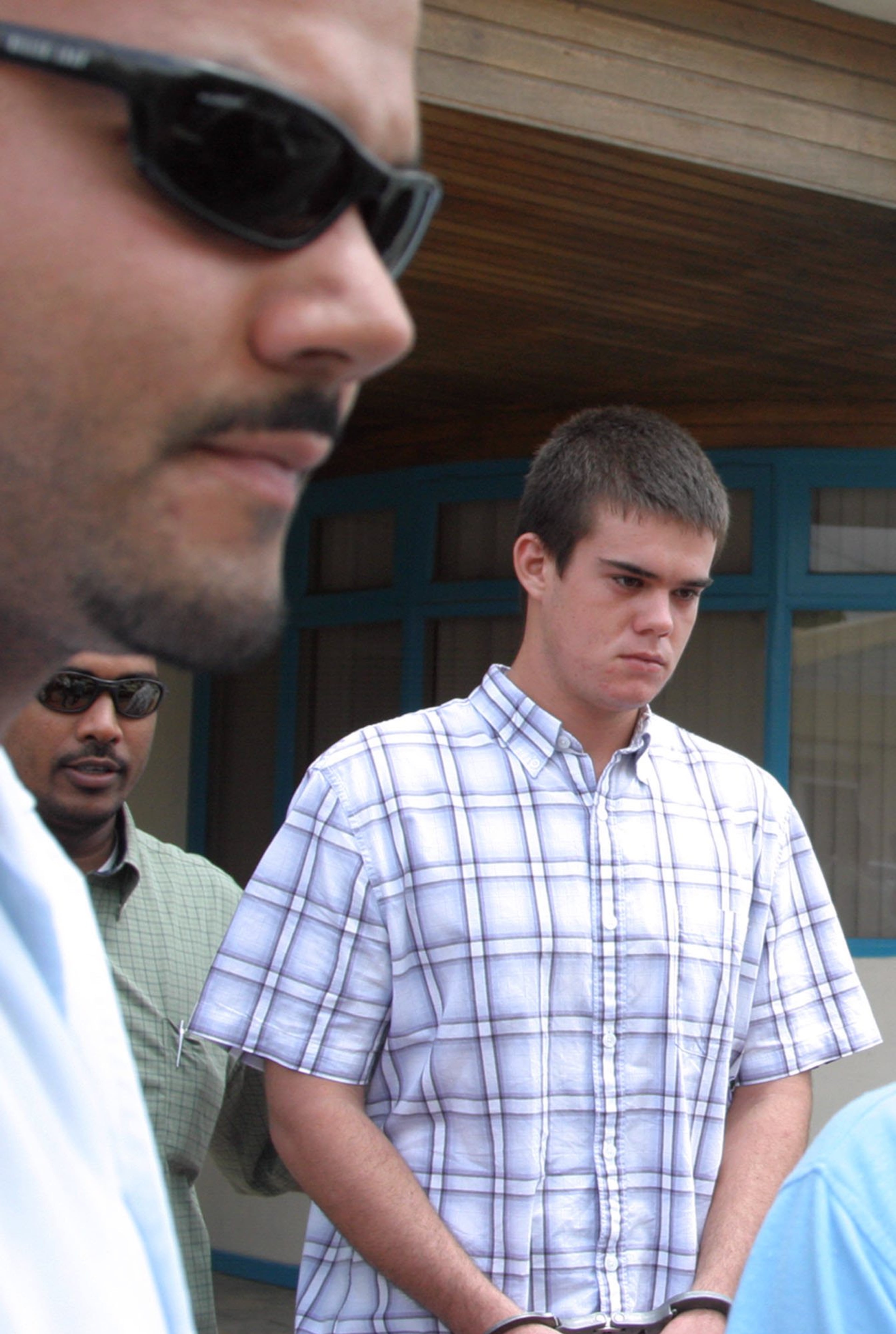 Joran van der Sloot is transferred from the police station to court in the capital city of Oranjestad, Saturday, June 11, 2005.