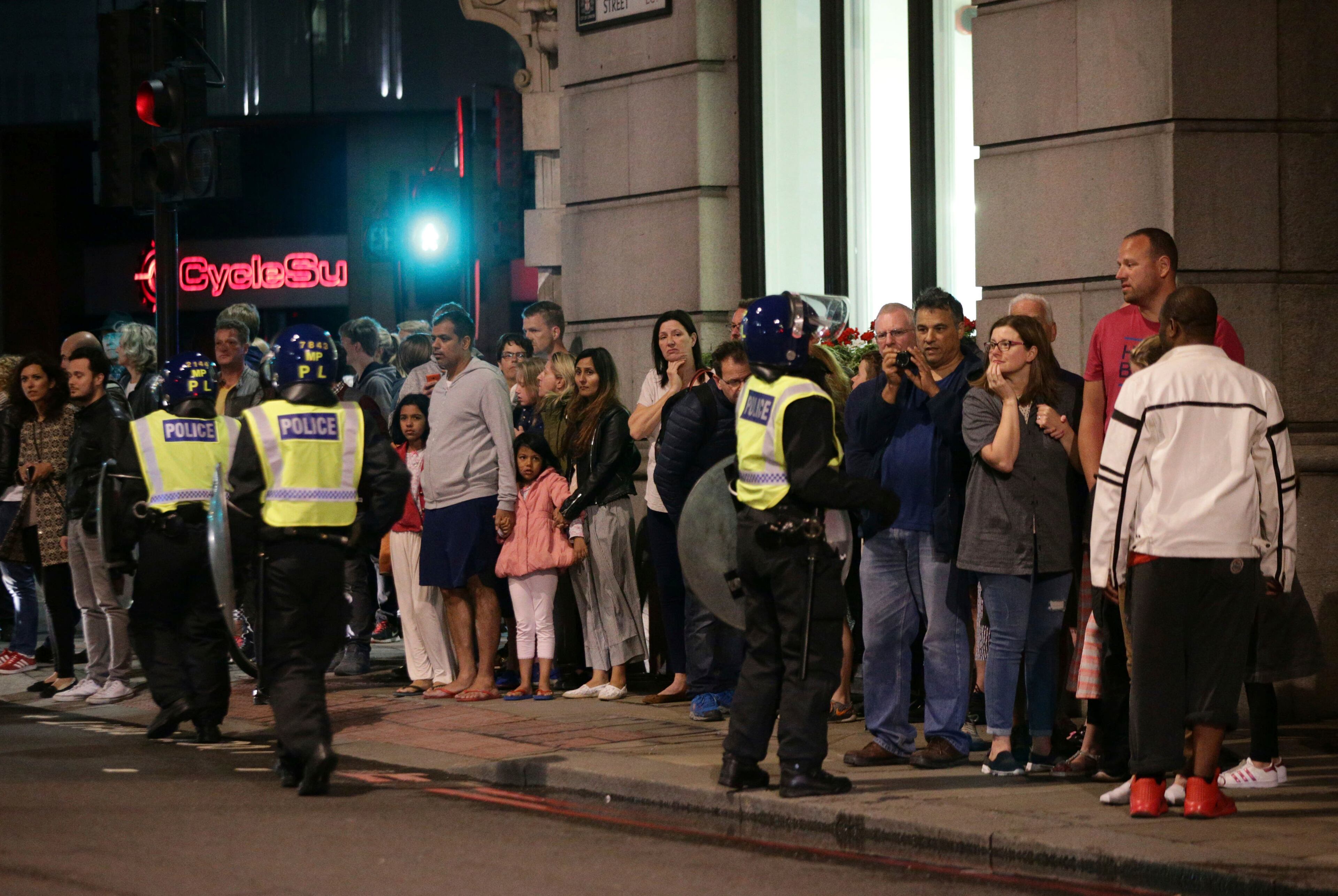 Guests from the Premier Inn Bankside Hotel are evacuated and kept in a group with police on Upper Thames Street following an incident in central London, Saturday, June 3, 2017. Terrorism struck at the heart of London, police said Sunday, after a vehicle veered off the road and mowed down pedestrians on London Bridge and gunshots rang out amid reports of knife attacks at nearby Borough Market. (Yui Mok/PA via AP)