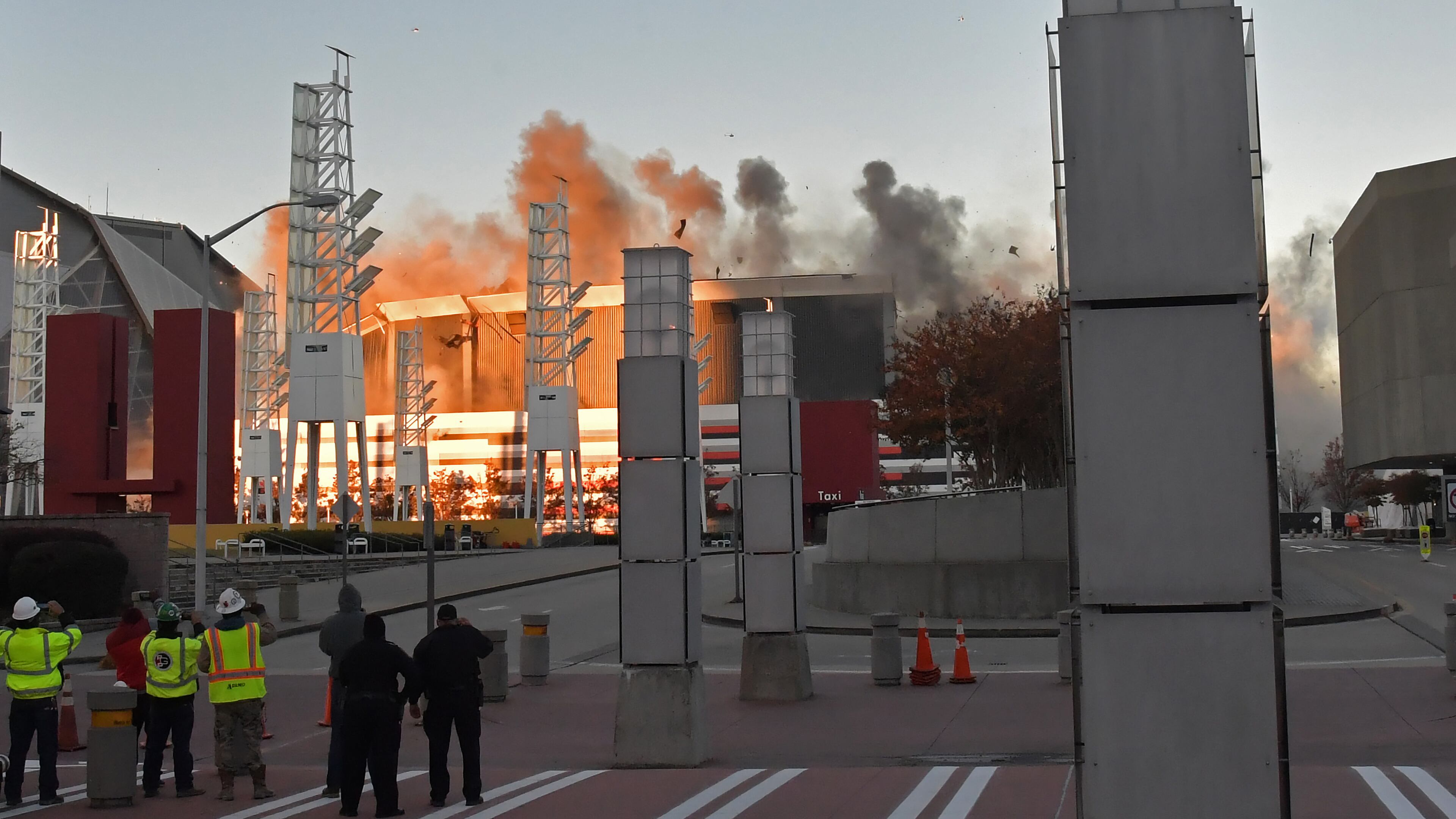 November 20, 2017 Atlanta - A view of the Georgia Dome implosion from media stage area on International Blvd in Atlanta on Monday, November 20, 2017. The Georgia Dome came down in a ball of dust Monday morning -- but not all of it fell. More than 300 pounds of explosives collapsed the steel in the upper ring and about 4,500 pounds of dynamite intended to crumble the concrete columns of the Atlanta institution of the last 25 years. HYOSUB SHIN / HSHIN@AJC.COM