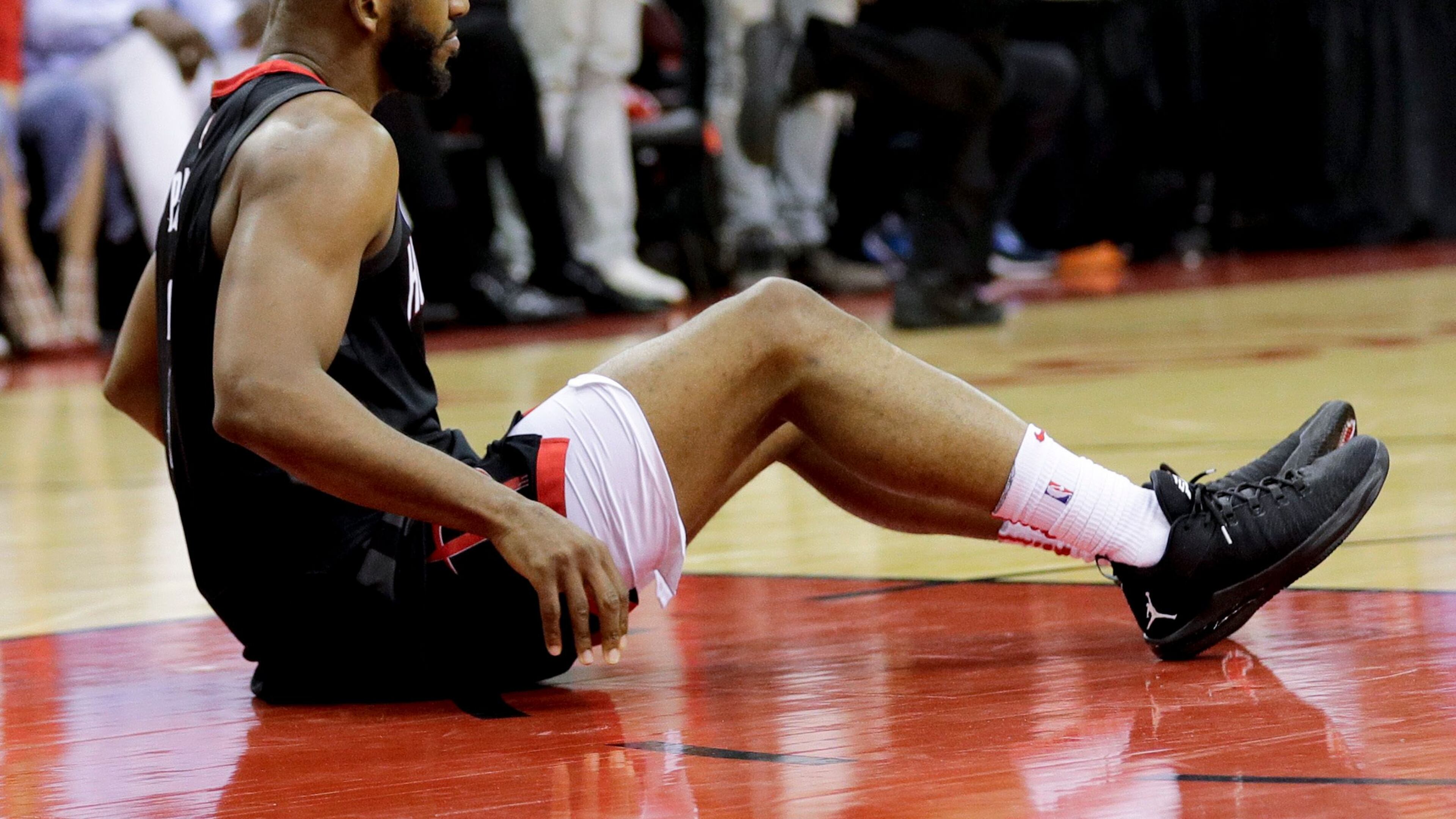 Houston Rockets guard Chris Paul sits on the floor after being hurt during the second half in Game 5 against the Golden State Warriors in the NBA basketball playoffs Western Conference finals in Houston, Thursday, May 24, 2018. (AP Photo/David J. Phillip)
