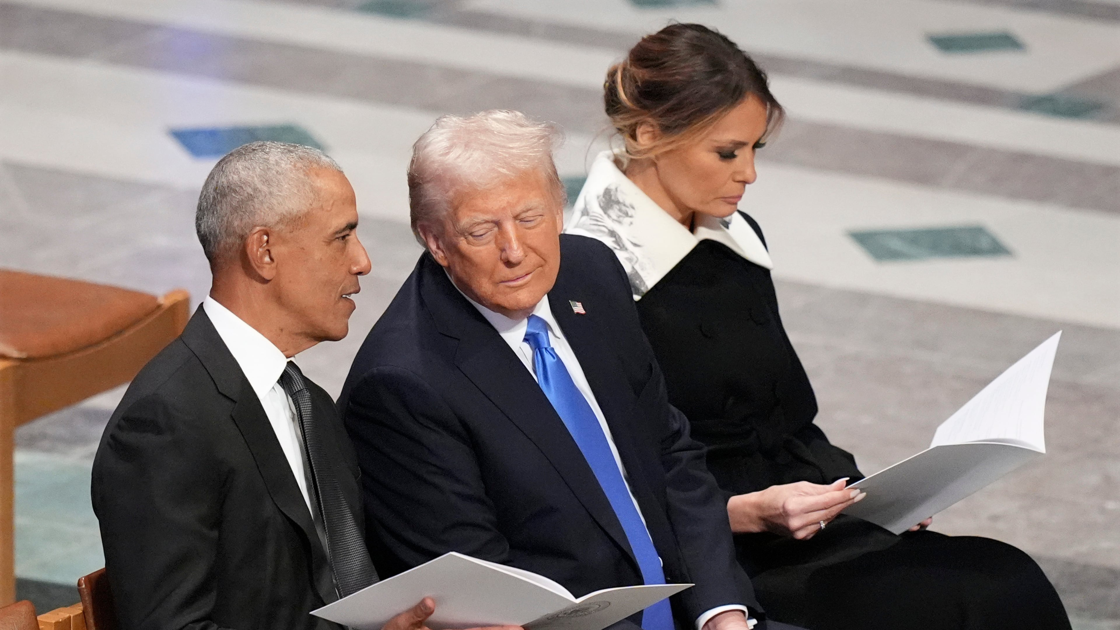 FILE - Former President Barack Obama talks with then President-elect Donald Trump as Melania Trump reads the funeral program before the state funeral for former President Jimmy Carter at Washington National Cathedral in Washington, Jan. 9, 2025. (AP Photo/Jacquelyn Martin, File)