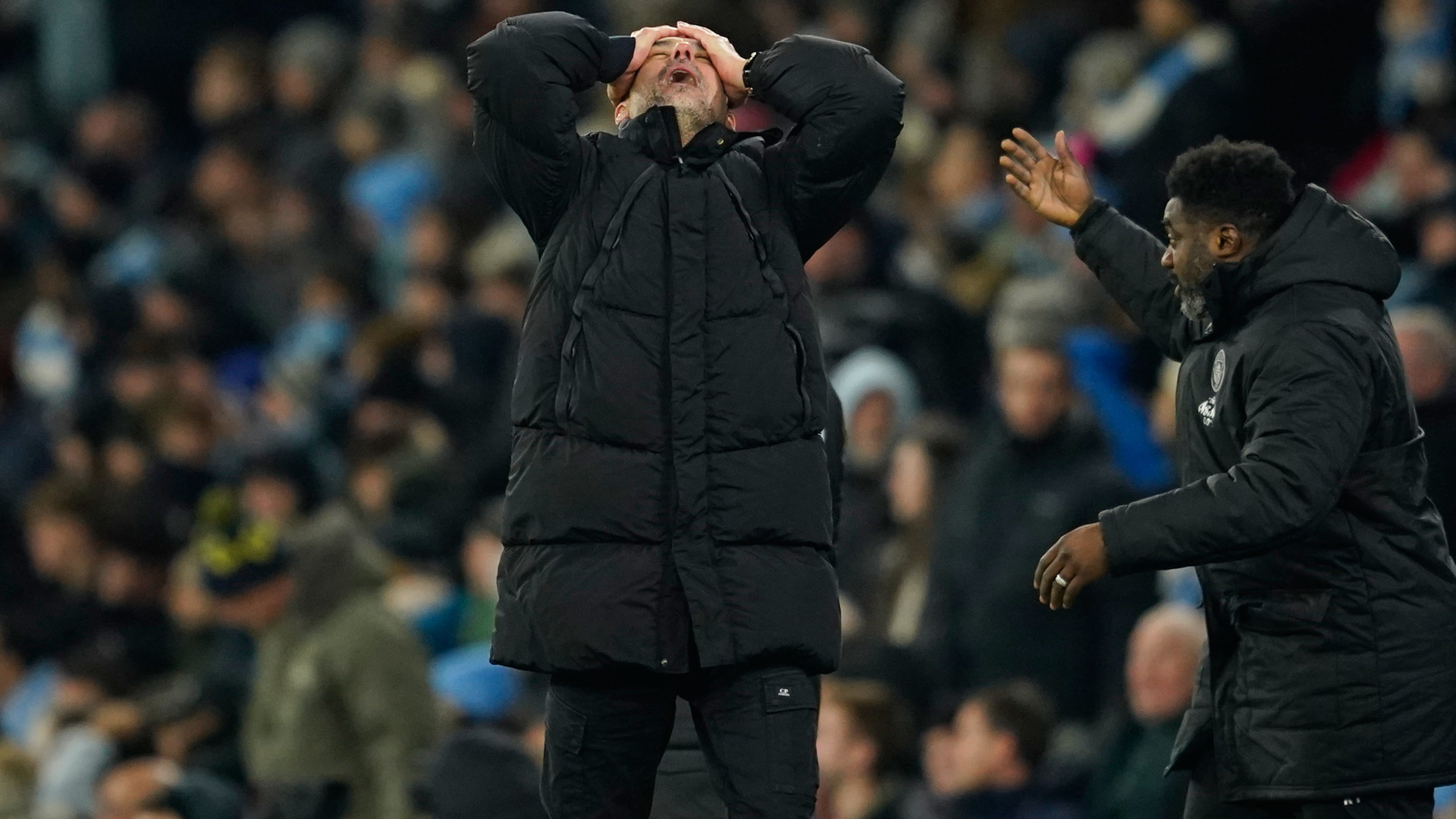 Manchester City's head coach Pep Guardiola, center, reacts after Chelsea's Enzo Fernandez scoring during the English Premier League soccer match between Manchester City and Chelsea in Manchester, England, Sunday, Jan. 4, 2026. (AP Photo/Dave Thompson)
