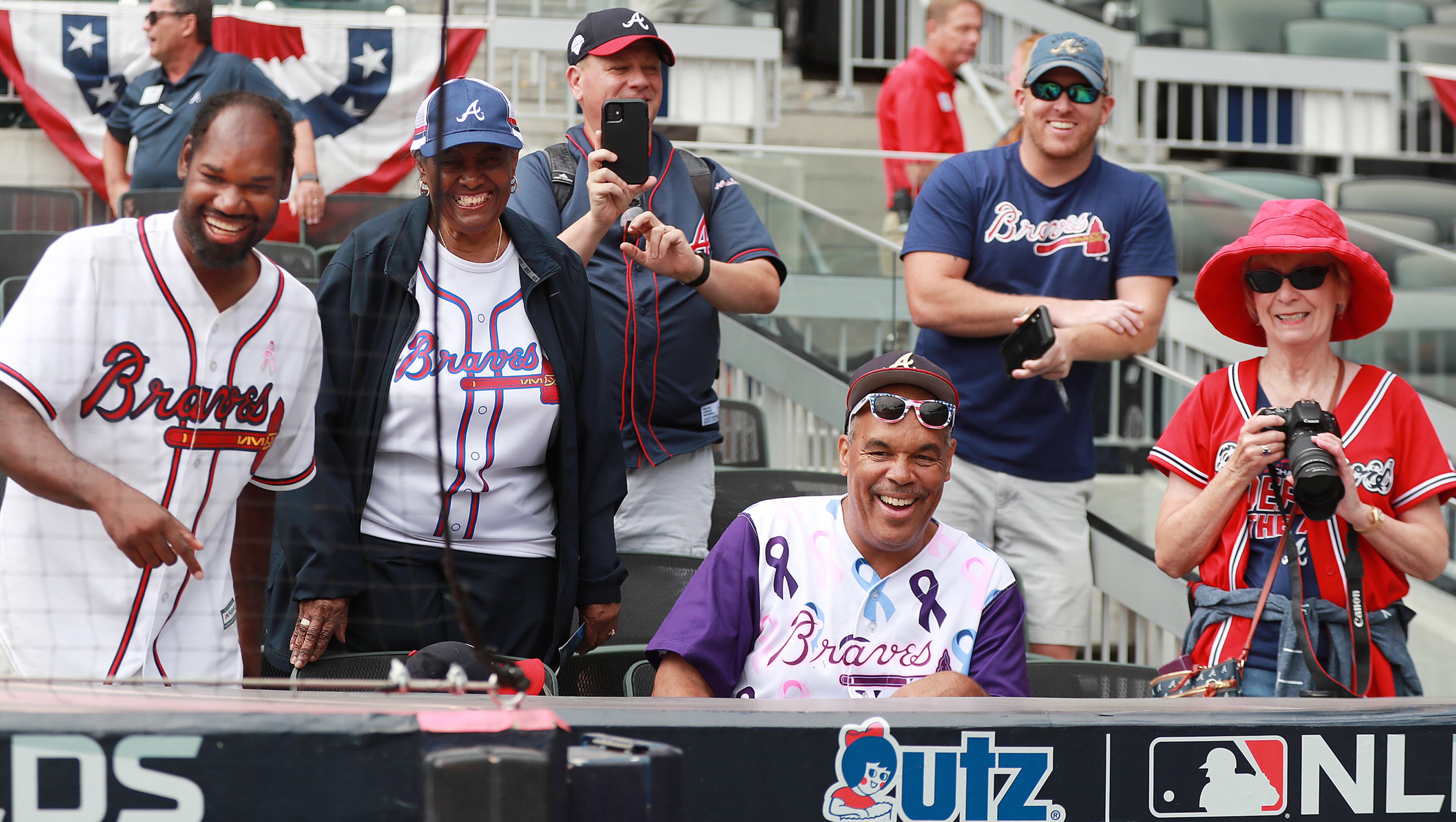Braves fans appear confident as they smile and snap photo as their team takes batting practice. Curtis Compton/ccompton@ajc.com