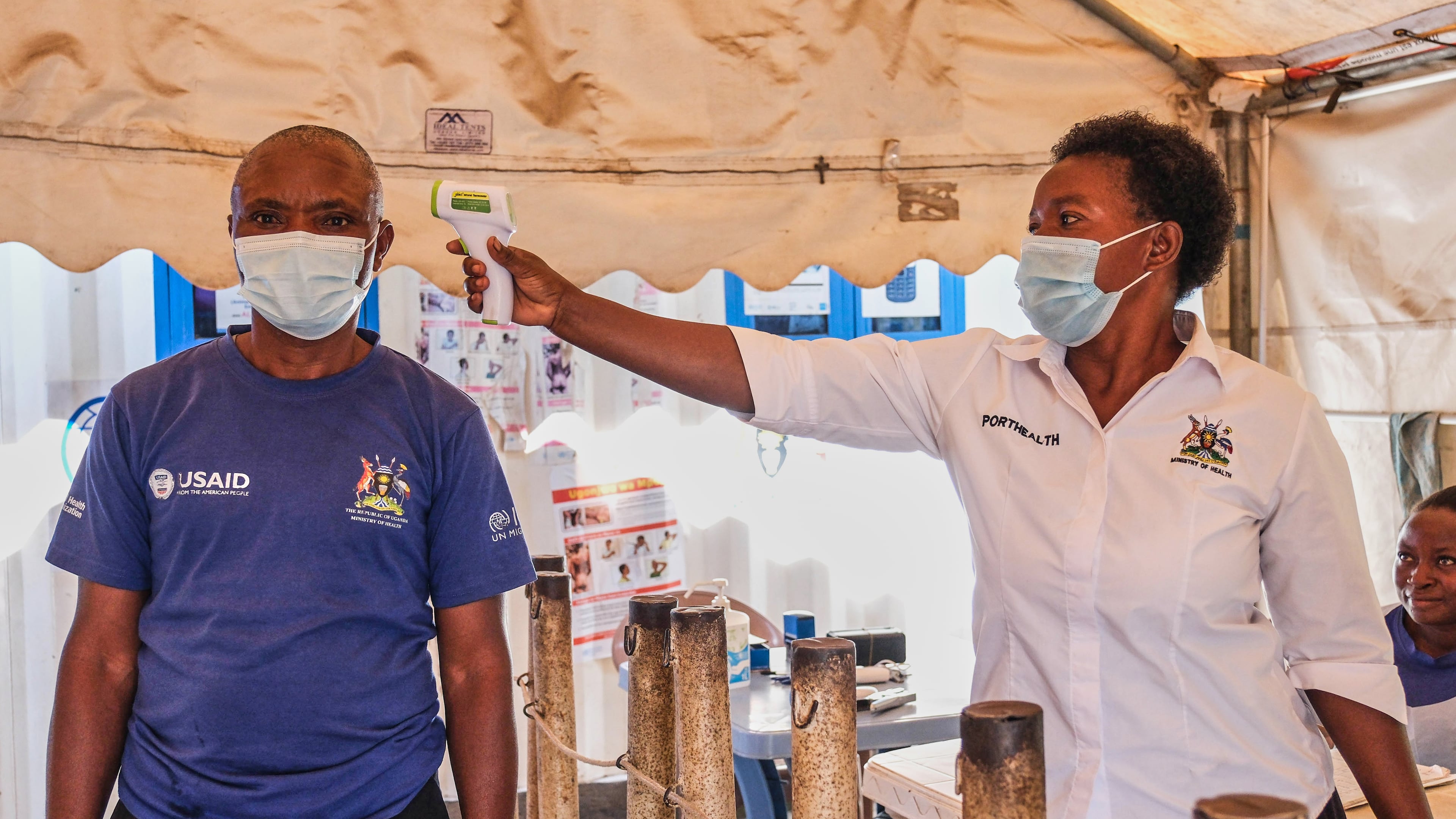 FILE - A health worker checks an individual's temperature at a temporary health clinic at the Mpondwe border crossing linking Uganda and the Democratic Republic of the Congo, June 4, 2026. (AP Photo/Hajarah Nalwadda, File)