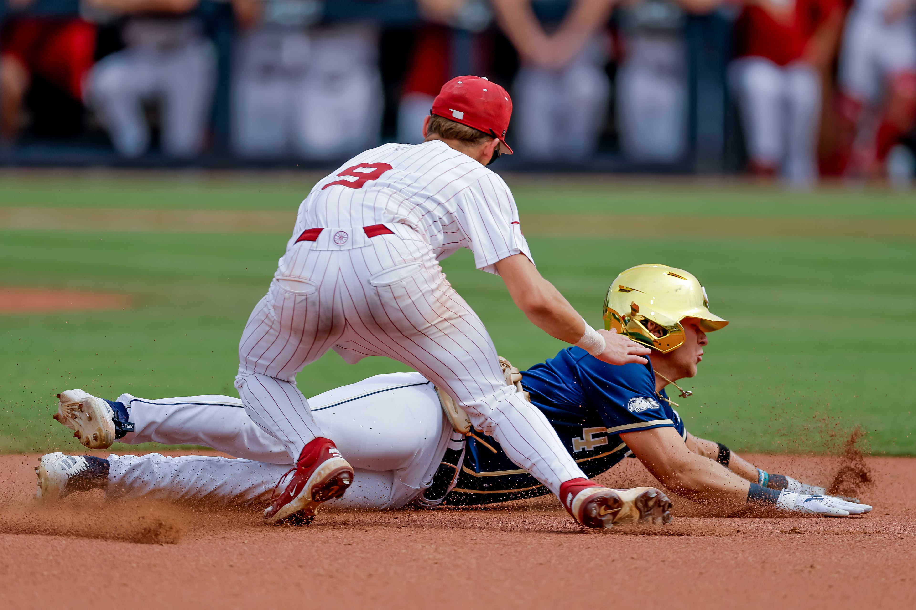 Georgia Tech's Alex Hernandez (4) slides in safe at third base against Oklahoma infielder Camden Johnson (9) during the sixth inning of the Atlanta Regional elimination baseball game at Russ Chandler Stadium, Monday, June 1, 2026, in Atlanta. (Erik S. Lesser for the AJC)