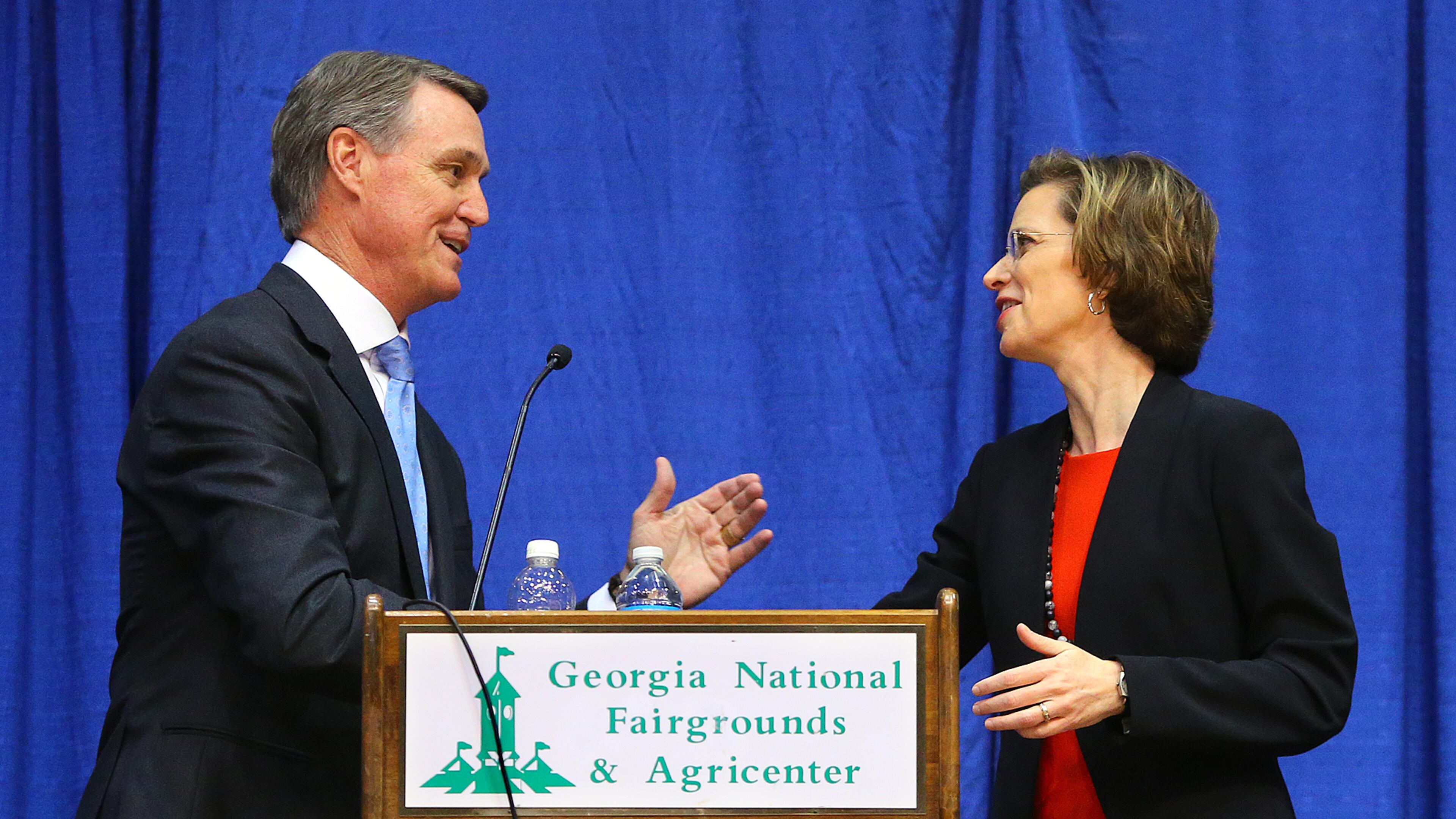 100714 PERRY: David Perdue and Michelle Nunn shake hands at the conclusion of the senate debate in Reaves Arena at the Georgia National Fair on Tuesday, Oct. 7, 2014, in Perry. CURTIS COMPTON / CCOMPTON@AJC.COM David Perdue and Michelle Nunn shake hands at the conclusion of the senate debate in Reaves Arena at the Georgia National Fair on Tuesday in Perry. Curtis Compton, ccompton@ajc.com