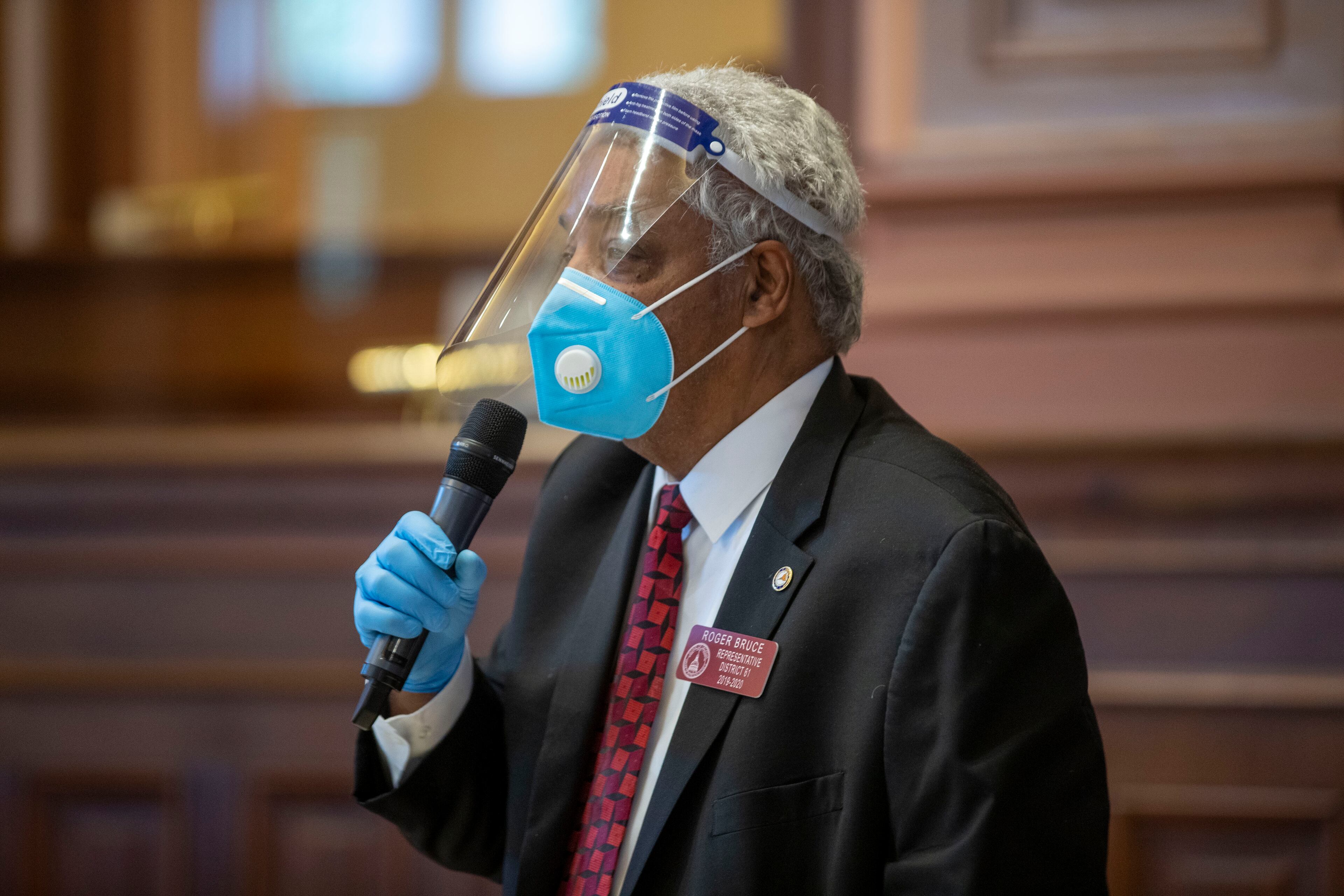06/15/2020 - Atlanta , Georgia - Georgia Rep. Roger Bruce (D-Atlanta) wears a face shield, gloves and a face mask, as he speaks in favor of HR 1507, which contains the change to the rules of the House, during the 30th day of the legislative session at the Georgia State Capitol building Atlanta, Monday, June 15, 2020. (ALYSSA POINTER / ALYSSA.POINTER@AJC.COM)
