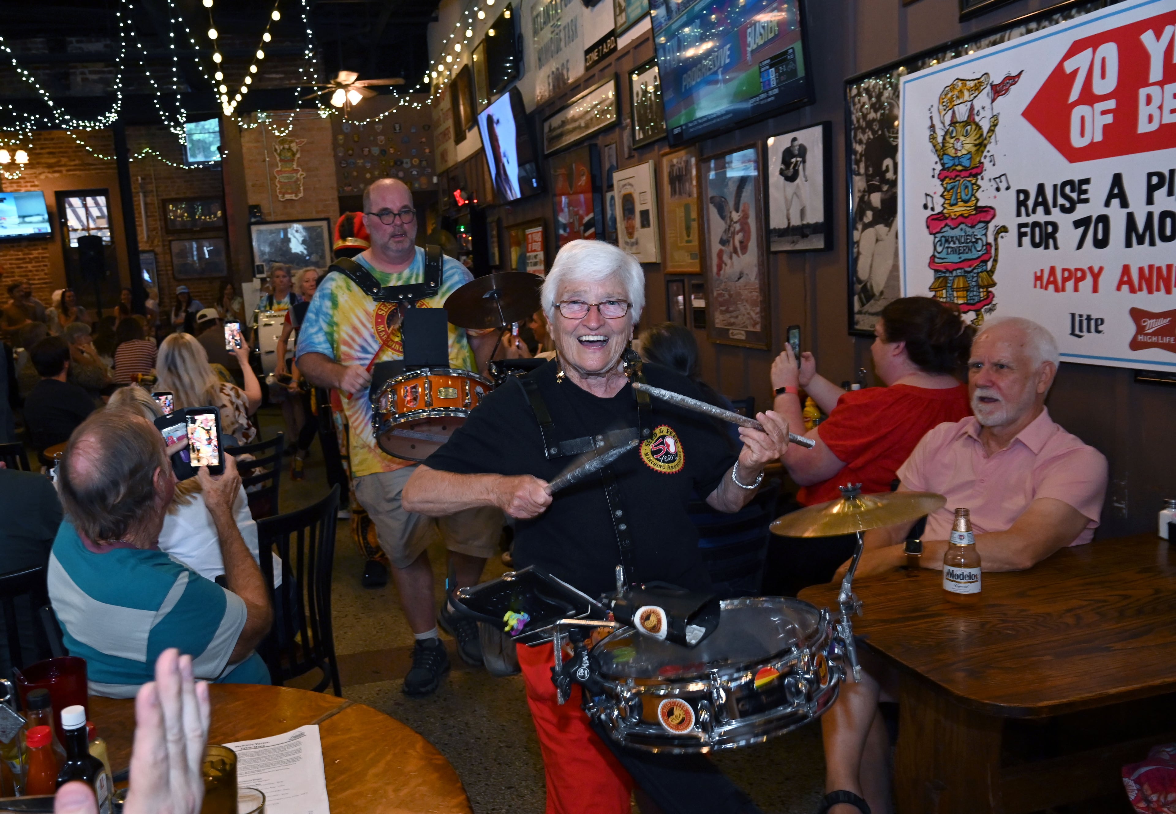 The Seed & Feed Marching Abominable marches through Manuel’s Tavern’s during their 70th anniversary celebration on Thursday, Aug. 6, 2026, in Atlanta. (Hyosub Shin/AJC)