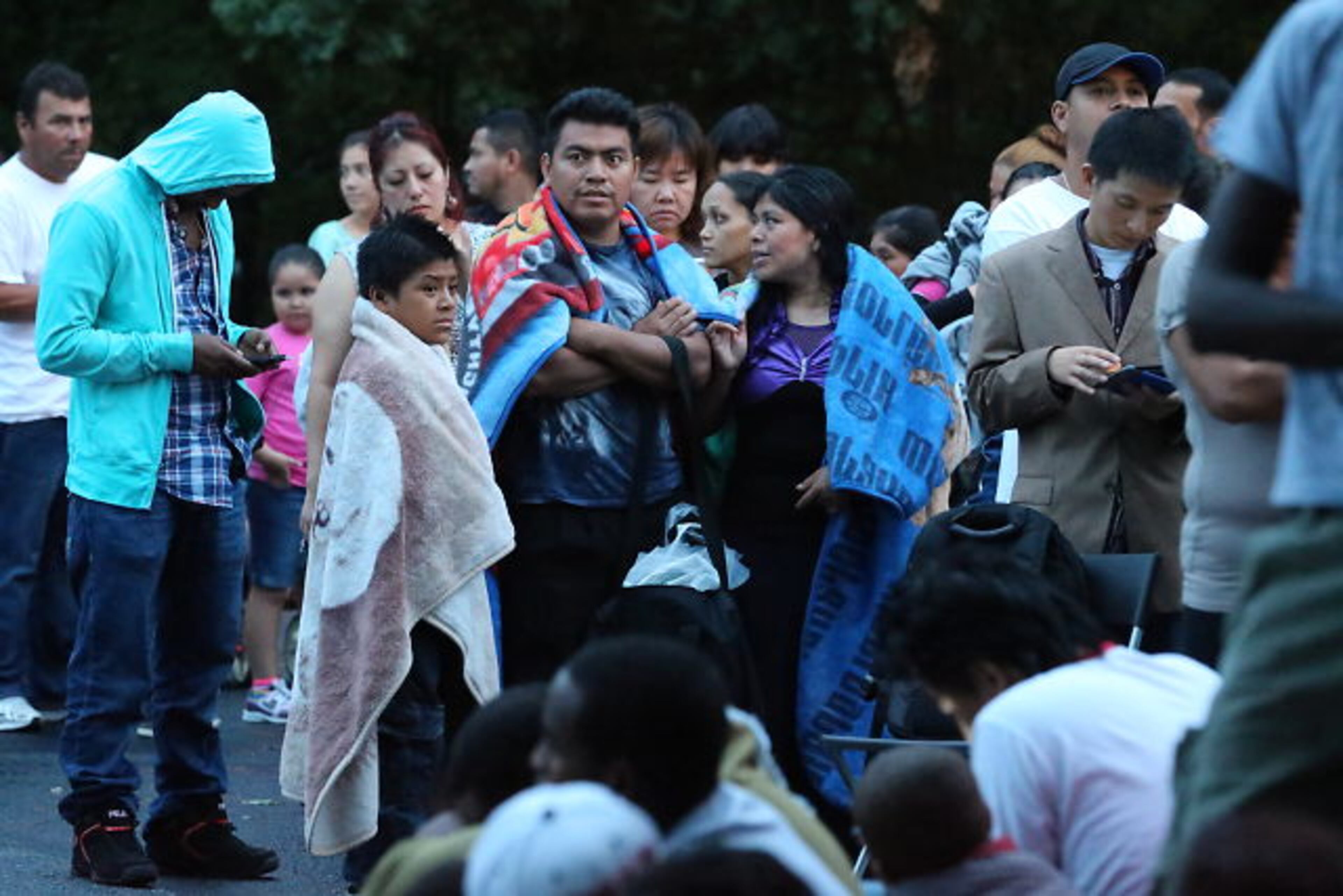 Hoping to get their children enrolled in DeKalb County Schools, immigrant families spent Thursday night and early Friday lined up with their children outside district headquarters.