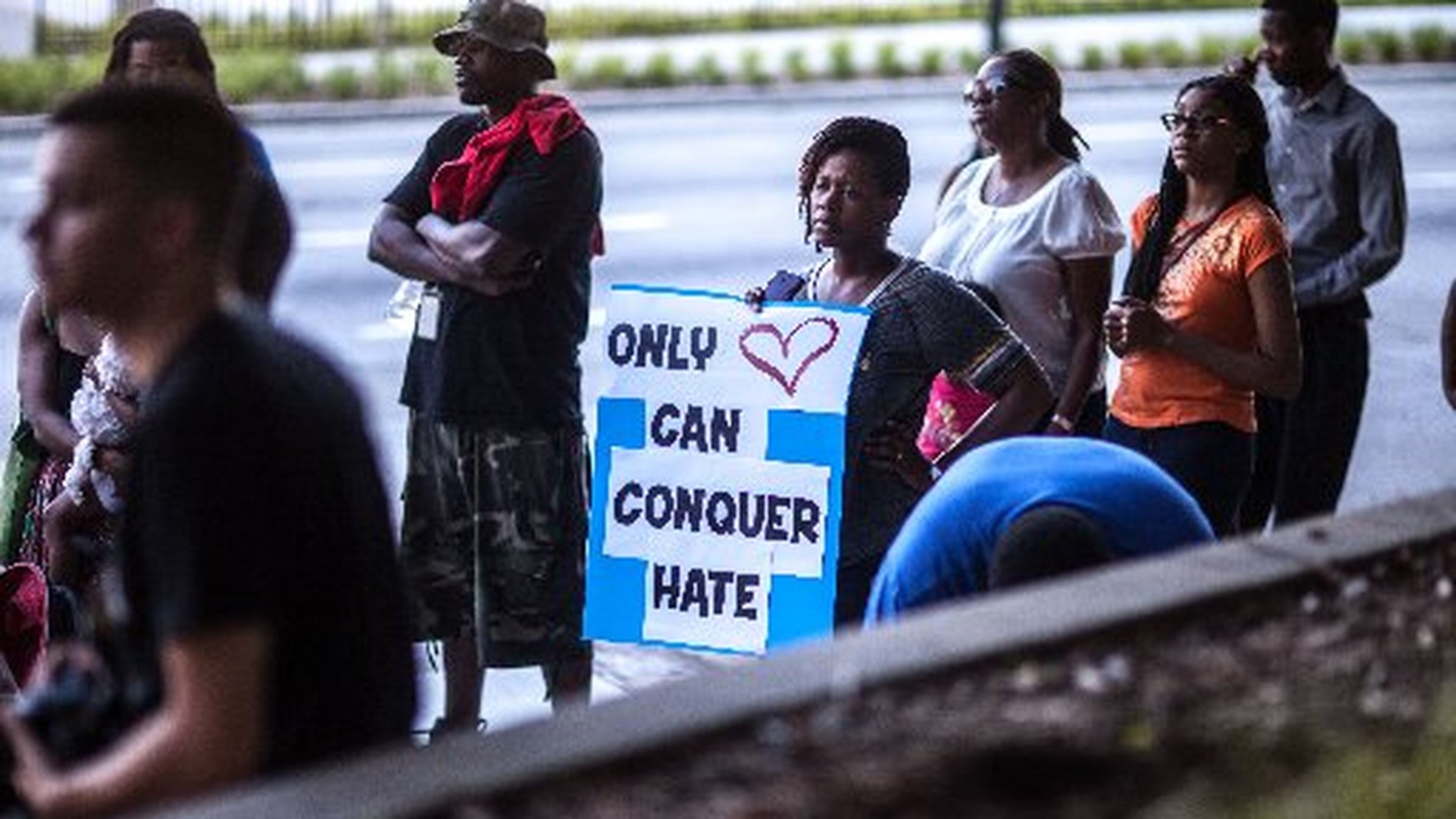 Katlyne Hill holds a sign at the state Capitol before a recent Remembrance March in Atlanta for the nine people killed at the historic Emanuel AME Church in Charleston, S.C. BRANDEN CAMP / SPECIAL