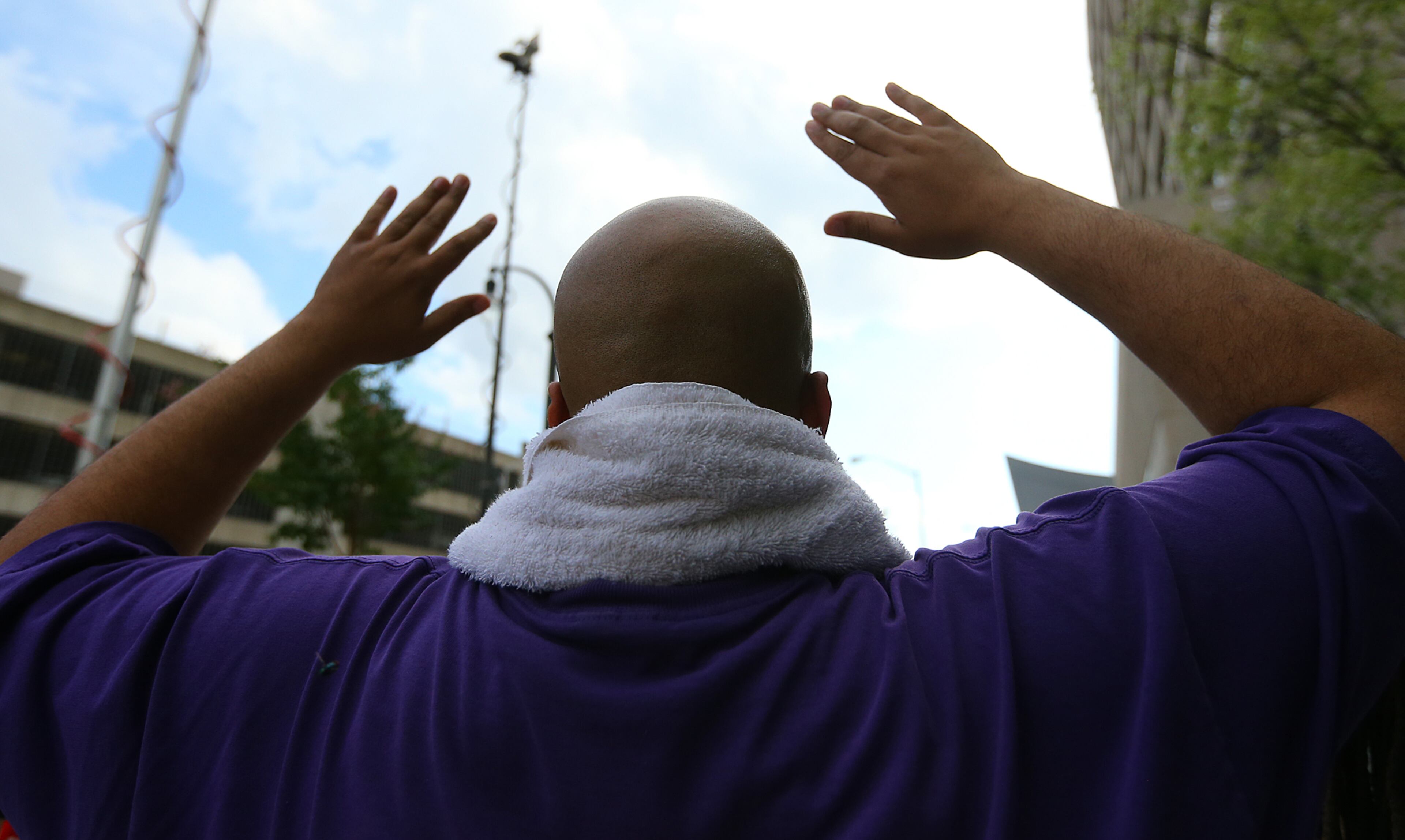 081814 Atlanta: Antonio Terry, Atlanta, raises his hands and shouts " hands up don't shoot" during a rally for Mike Brown and Ferguson outside the CNN Center on Monday, August 18, 2014, in Atlanta. CURTIS COMPTON / CCOMPTON@AJC.COM