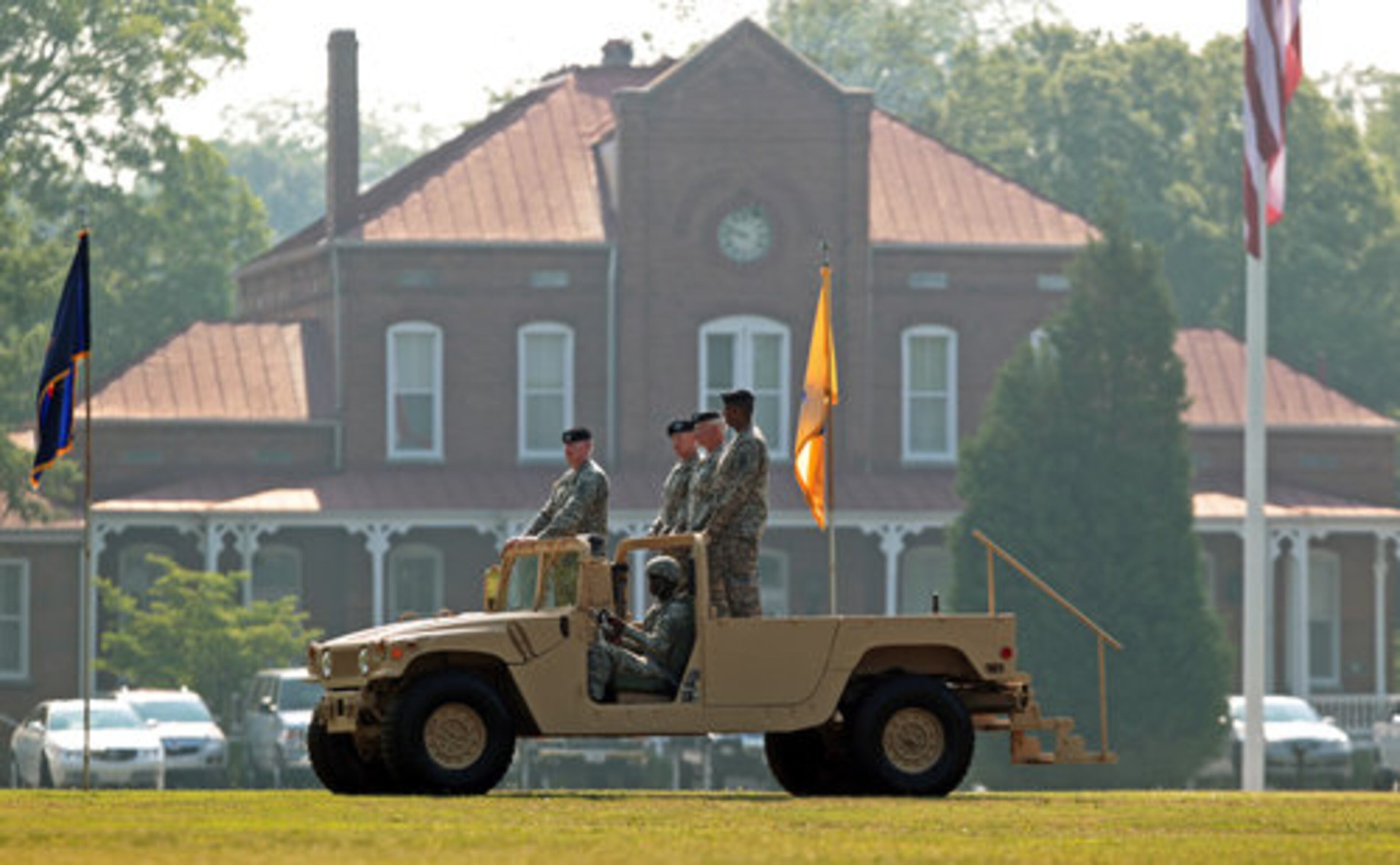 President Barack Obama's nominee for chairman of the joint chiefs of staff, Gen. Martin Dempsey (second from left, standing), rides in a humvee at the ceremony.