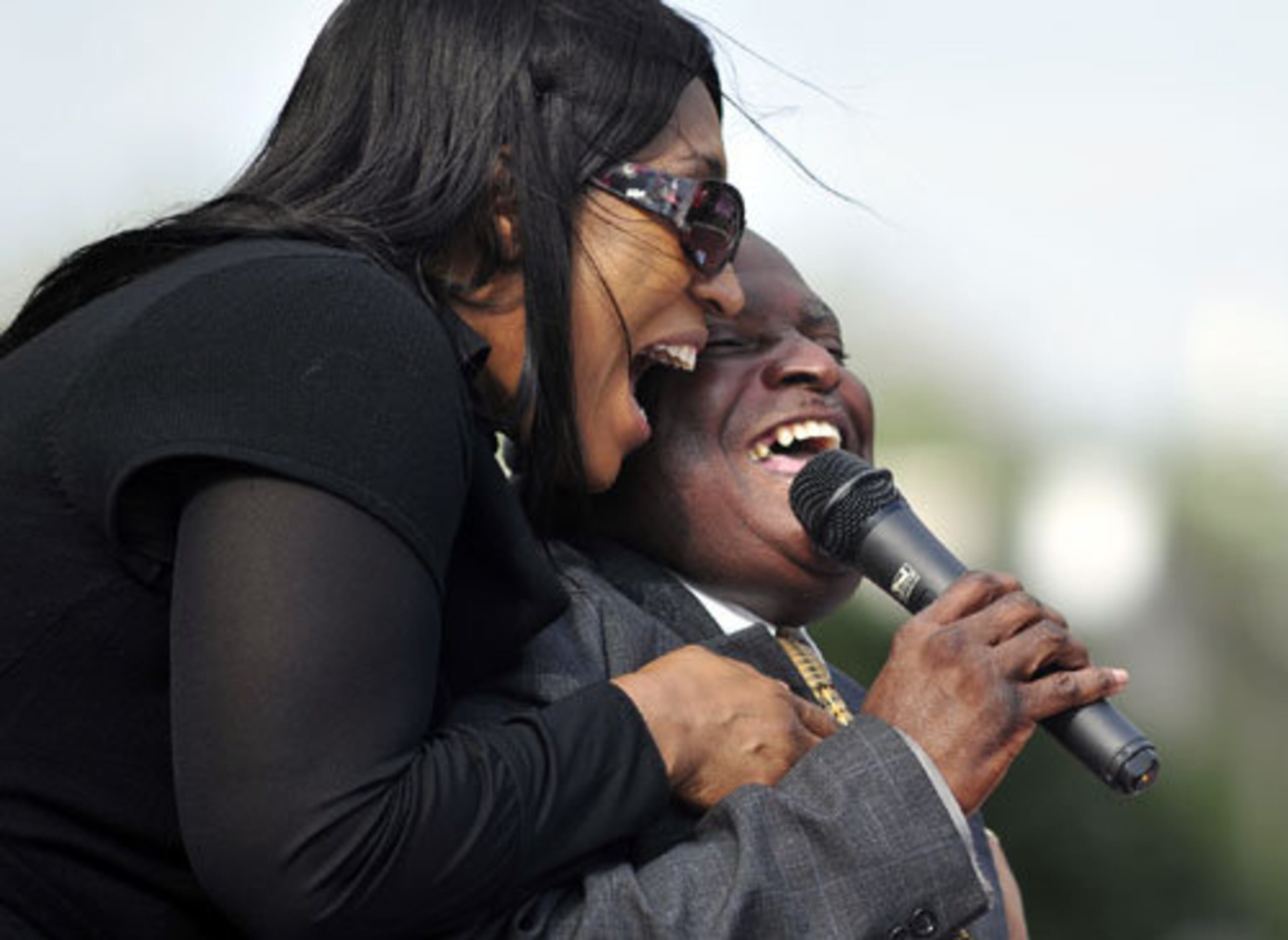 Joe Frazier's daughter Jacqui Frazier Lyde, left, sings with Scott Gibbs during a memorial service for the former heavyweight champion.