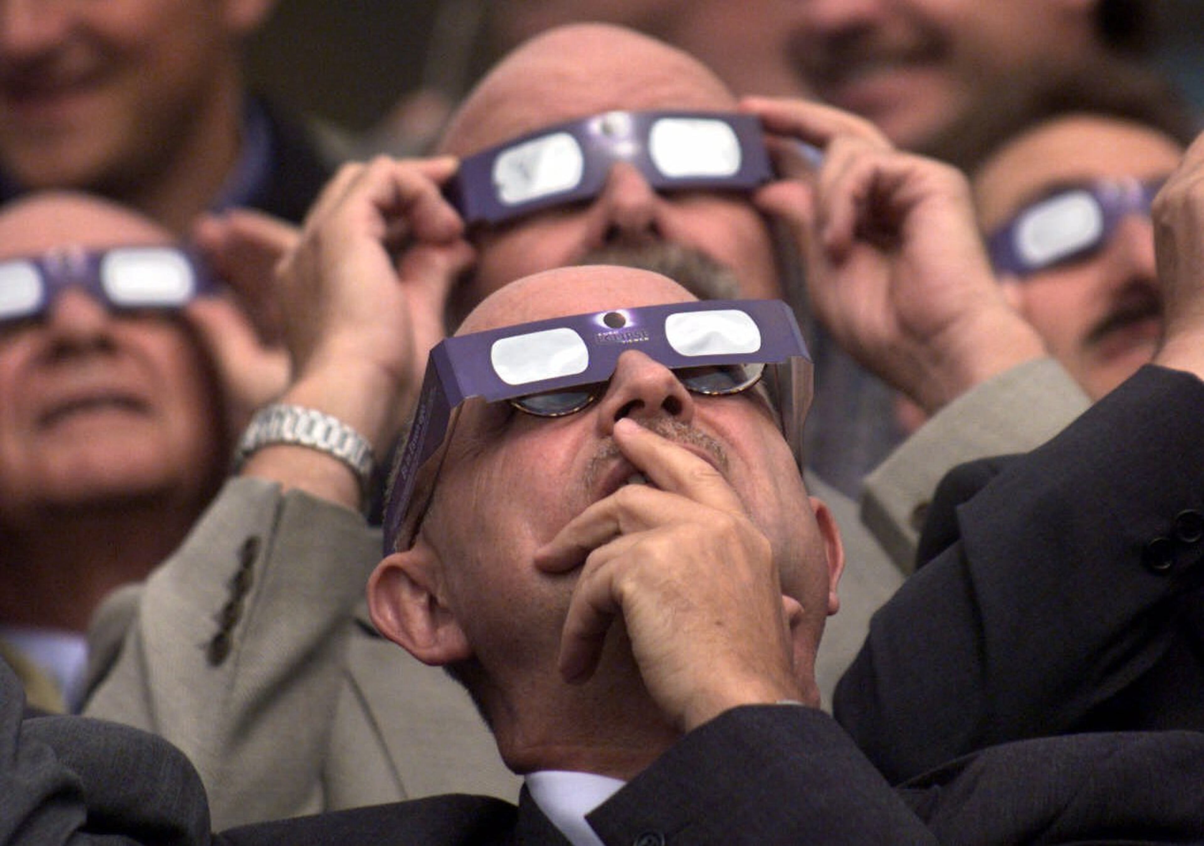 A group of businessmen watch the solar eclipse in Essen, Germany, on Wednesday, August 11, 1999. The moon smothered the light of the sun Wednesday as the last total solar eclipse of the millennium swept across Europe toward the Bay of Bengal.(AP Photo/Edgar R. Schoepal)