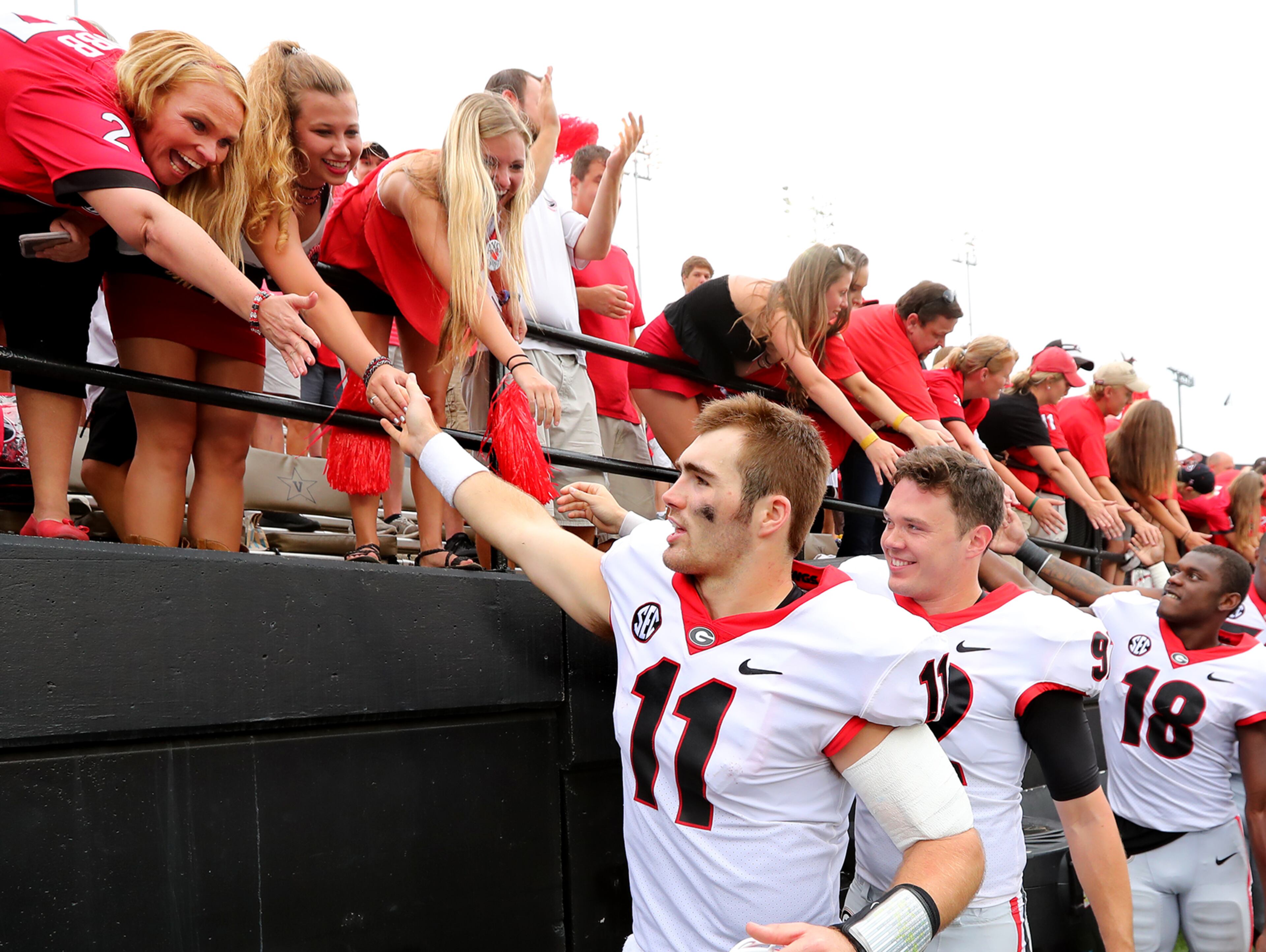 October 7, 2017 Nashville: Georgia quarterback Jake Fromm and the Bulldogs celebrate a 45-14 victory over Vanderbilt with fans during a NCAA college football game on Saturday, October 7, 2017, in Nashville. Curtis Compton/ccompton@ajc.com