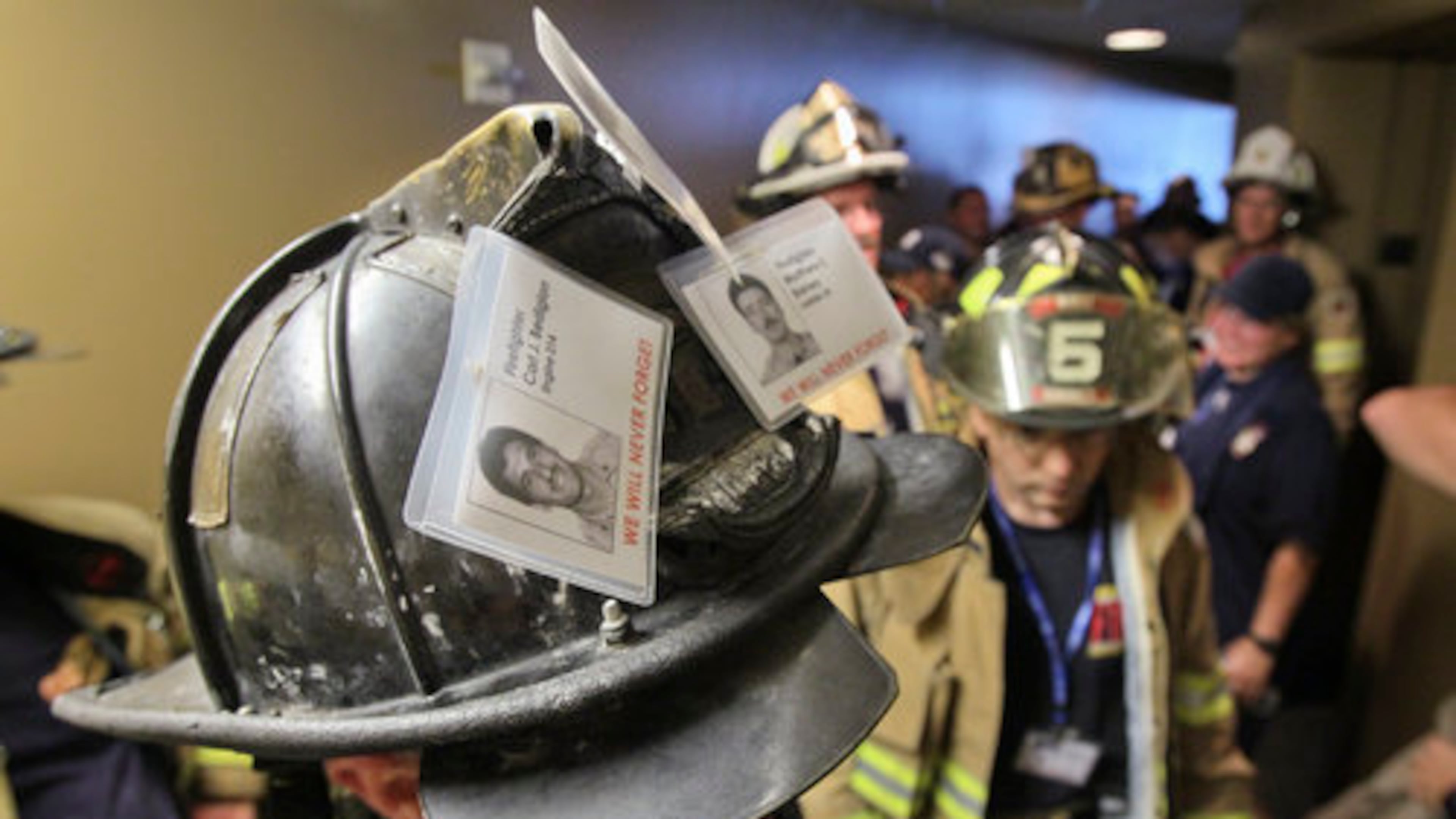 Firefighter Alton Lee of Jefferson Fire Rescue wore photos of three fallen New York firefighters from 9-11 on his climb. (John Spink/AJC)