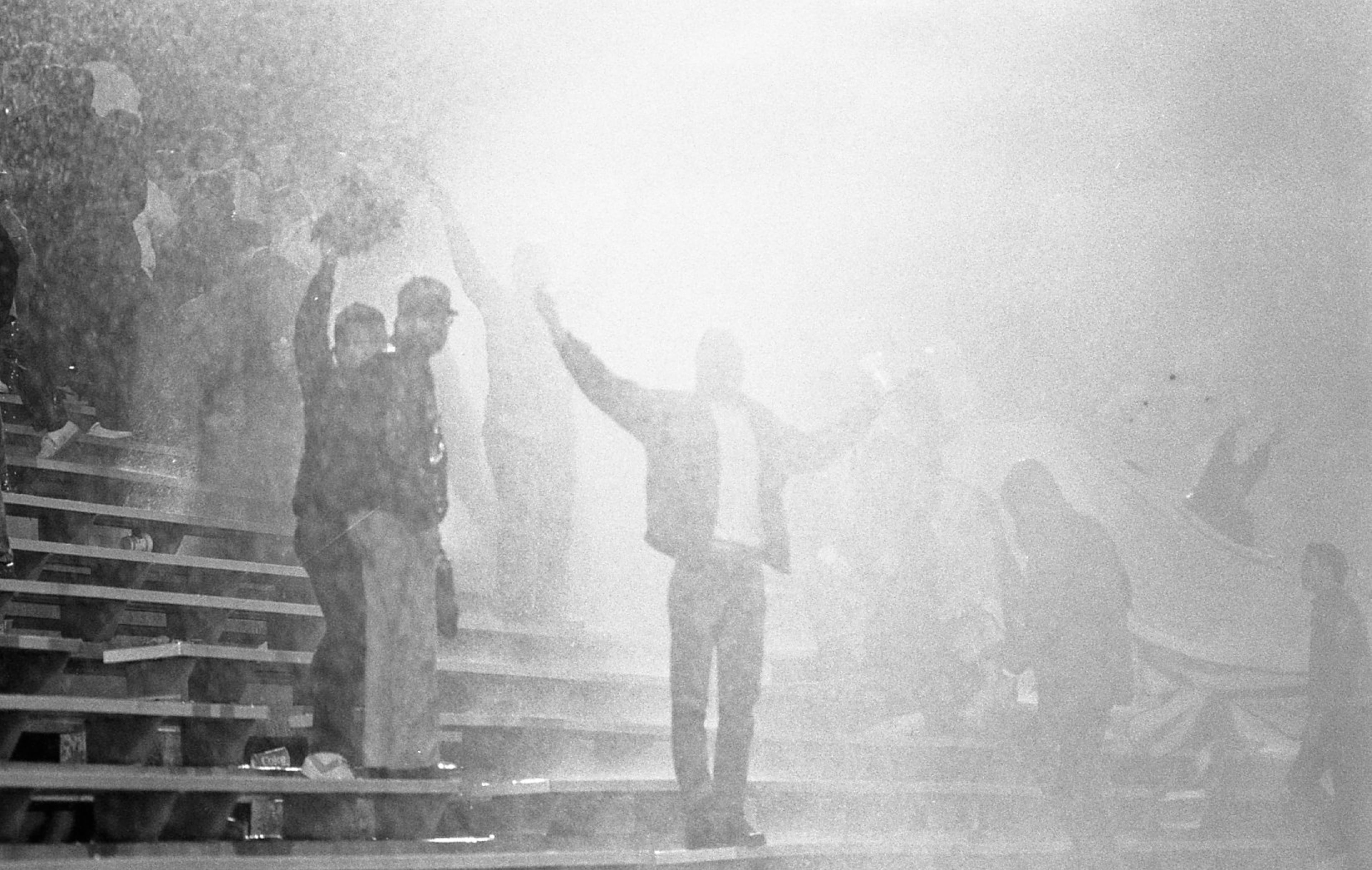 Fans in the stands get sprayed by the powerful water hoses. Photo by Louie Favorite / AJC